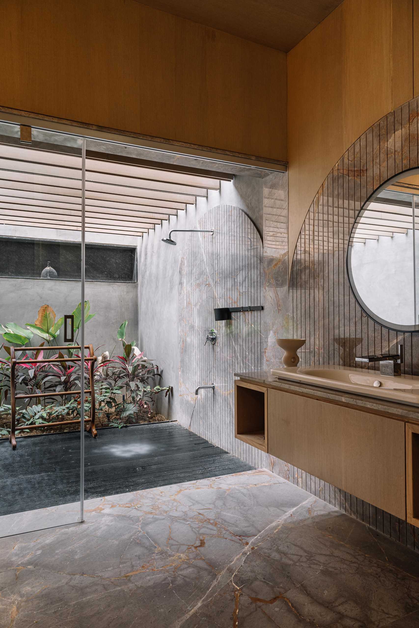 A modern bathroom with a private outdoor shower.