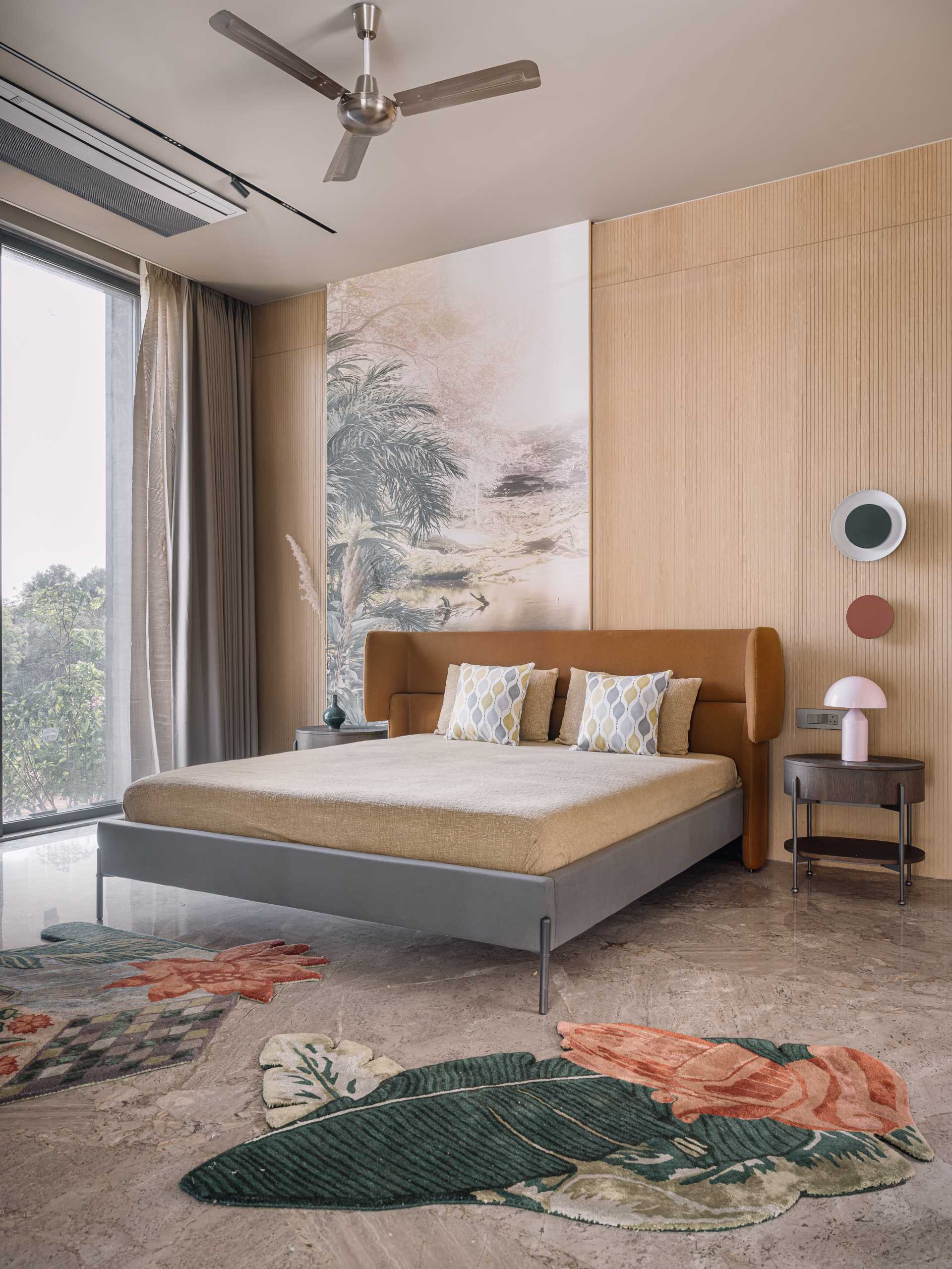 A modern bedroom with high ceilings and artwork.