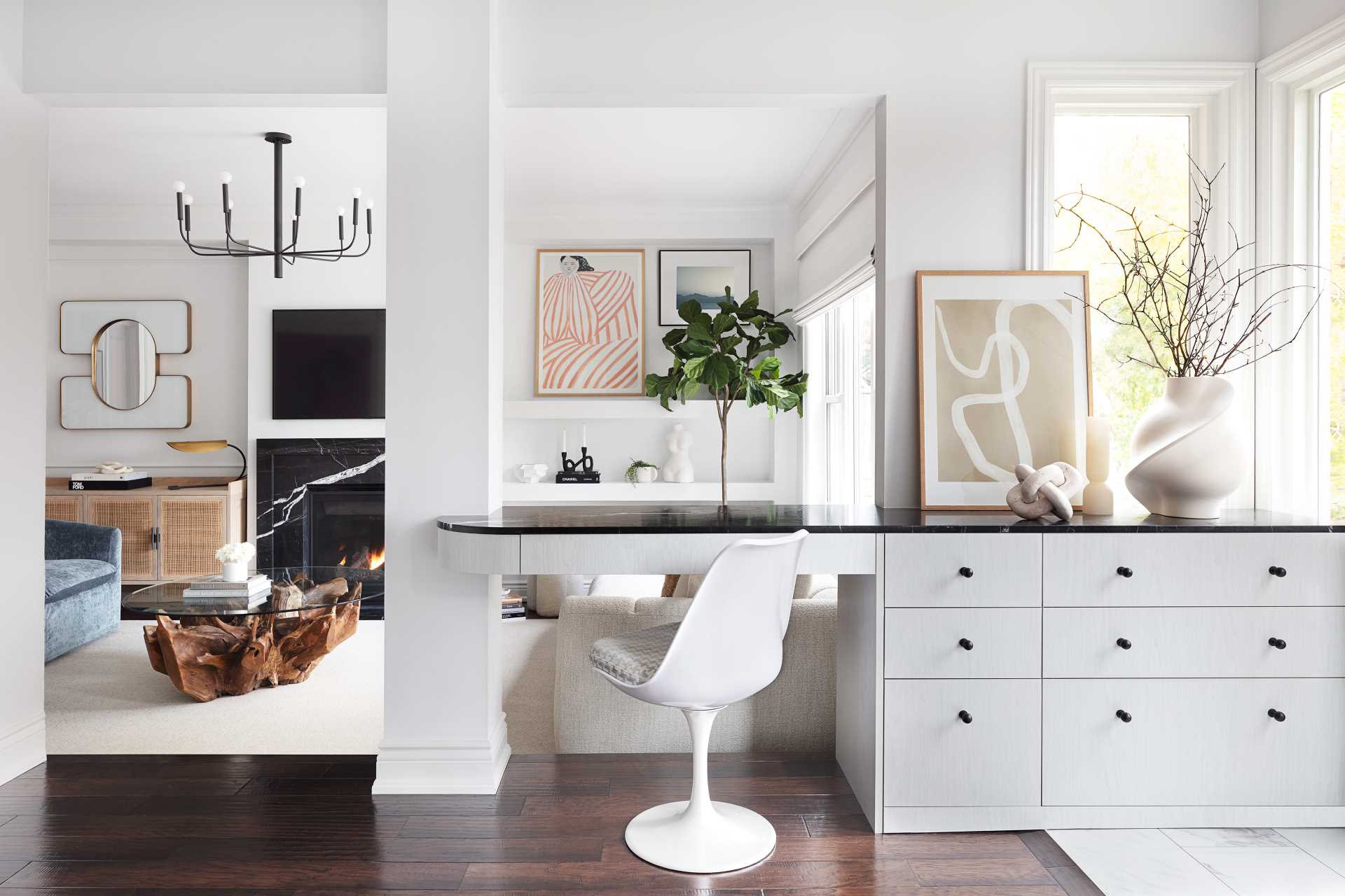 A contemporary interior with cabinets that transition into a desk.