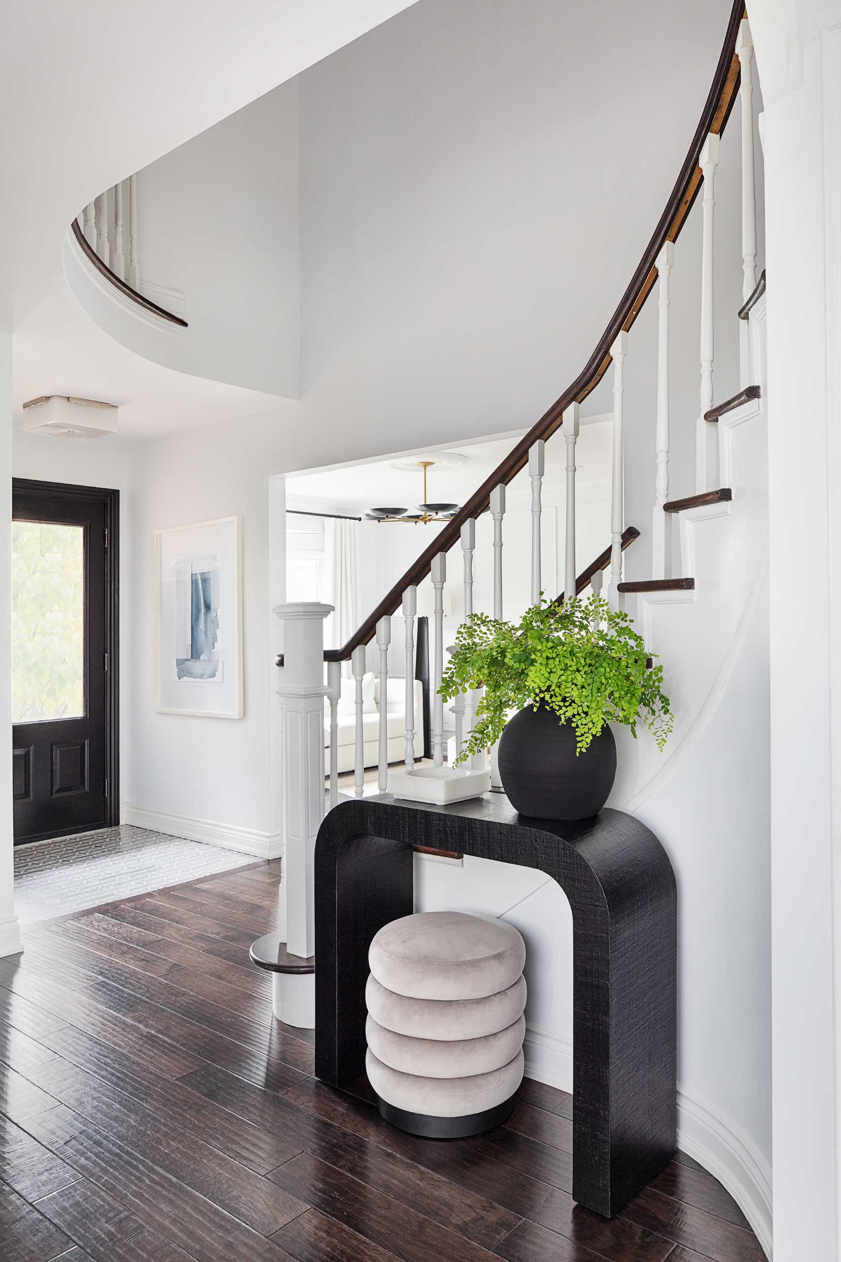 The stairs by the front door lead up to the second floor of the home.