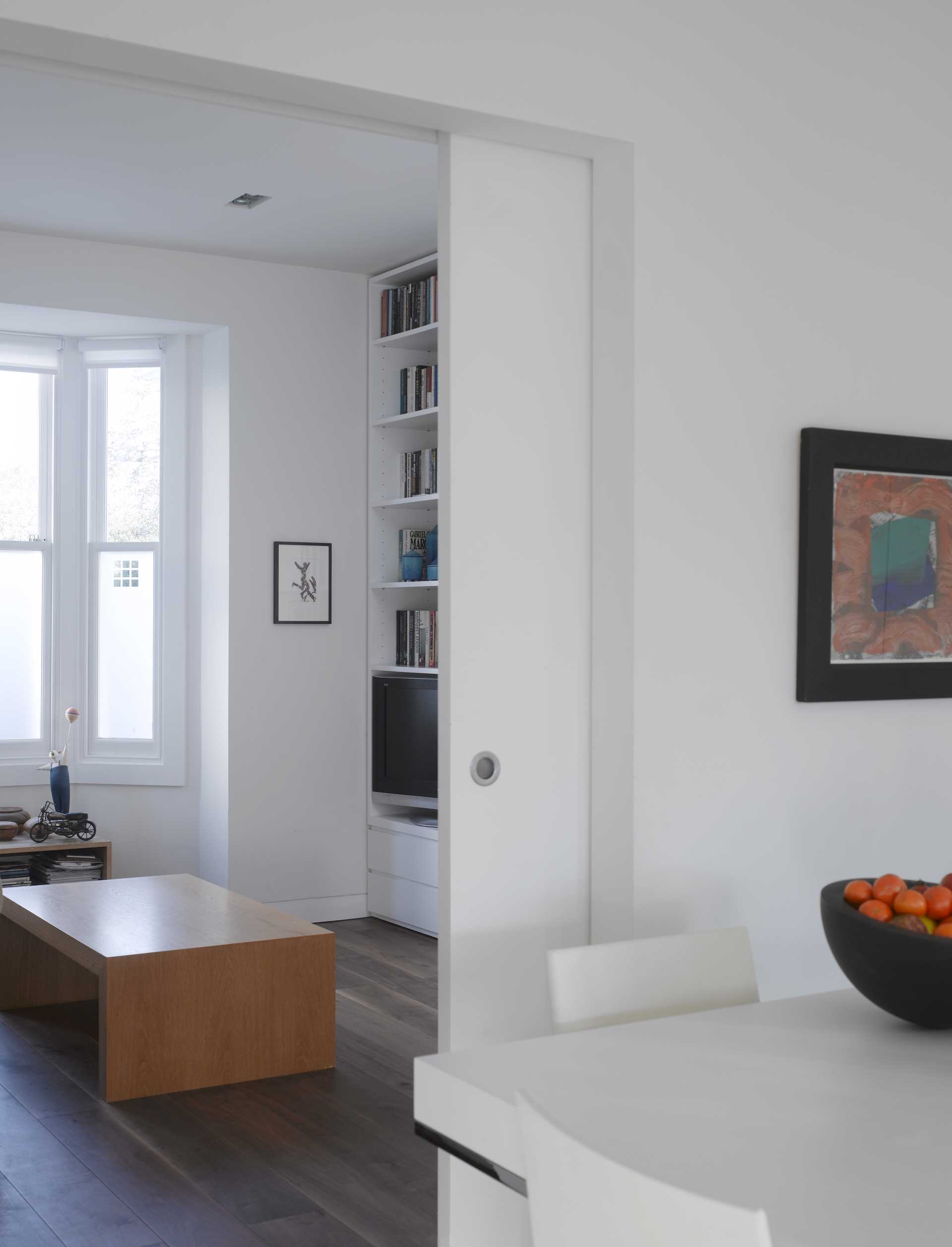 This front living room is separated from the kitchen and dining area with a large sliding wall, allowing the homeowners to acoustically seal away the TV sounds.