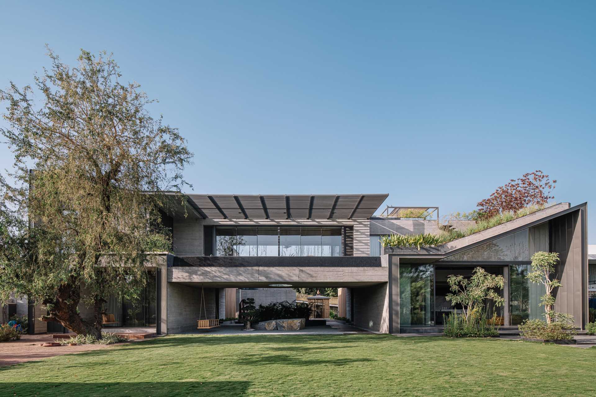 Expanses of glass are paired with modern lines, green roofs and overhanging gardens, board-formed concrete, as well as metal and wood siding.