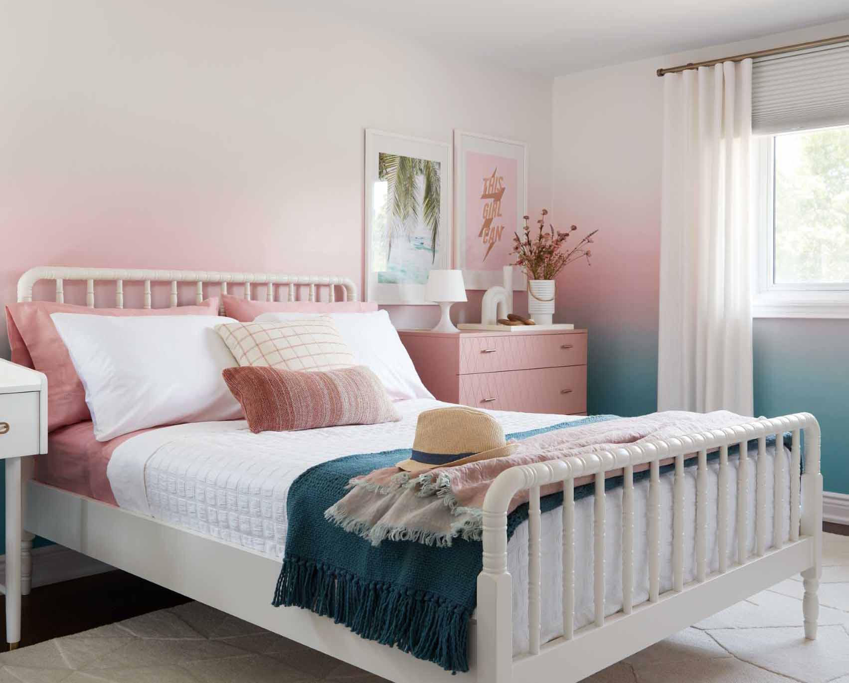 A colorful bedroom includes blue-to-pink ombre wallpaper with matching furniture and accessories.