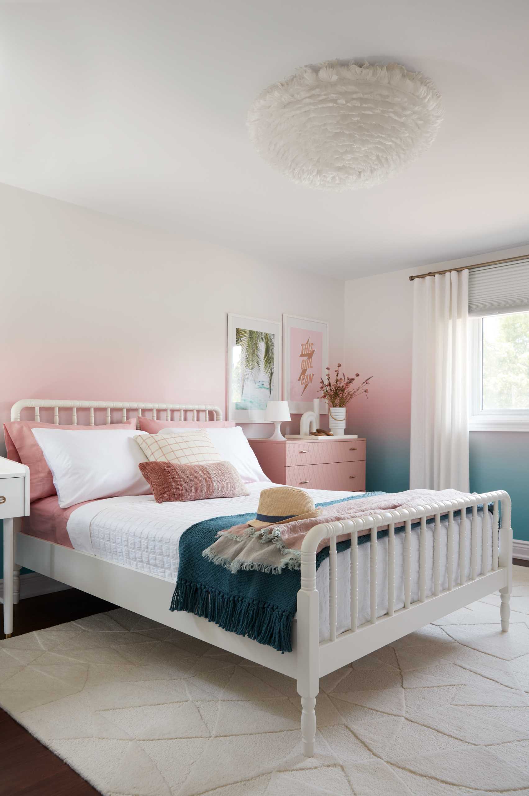 A colorful bedroom includes blue-to-pink ombre wallpaper with matching furniture and accessories.