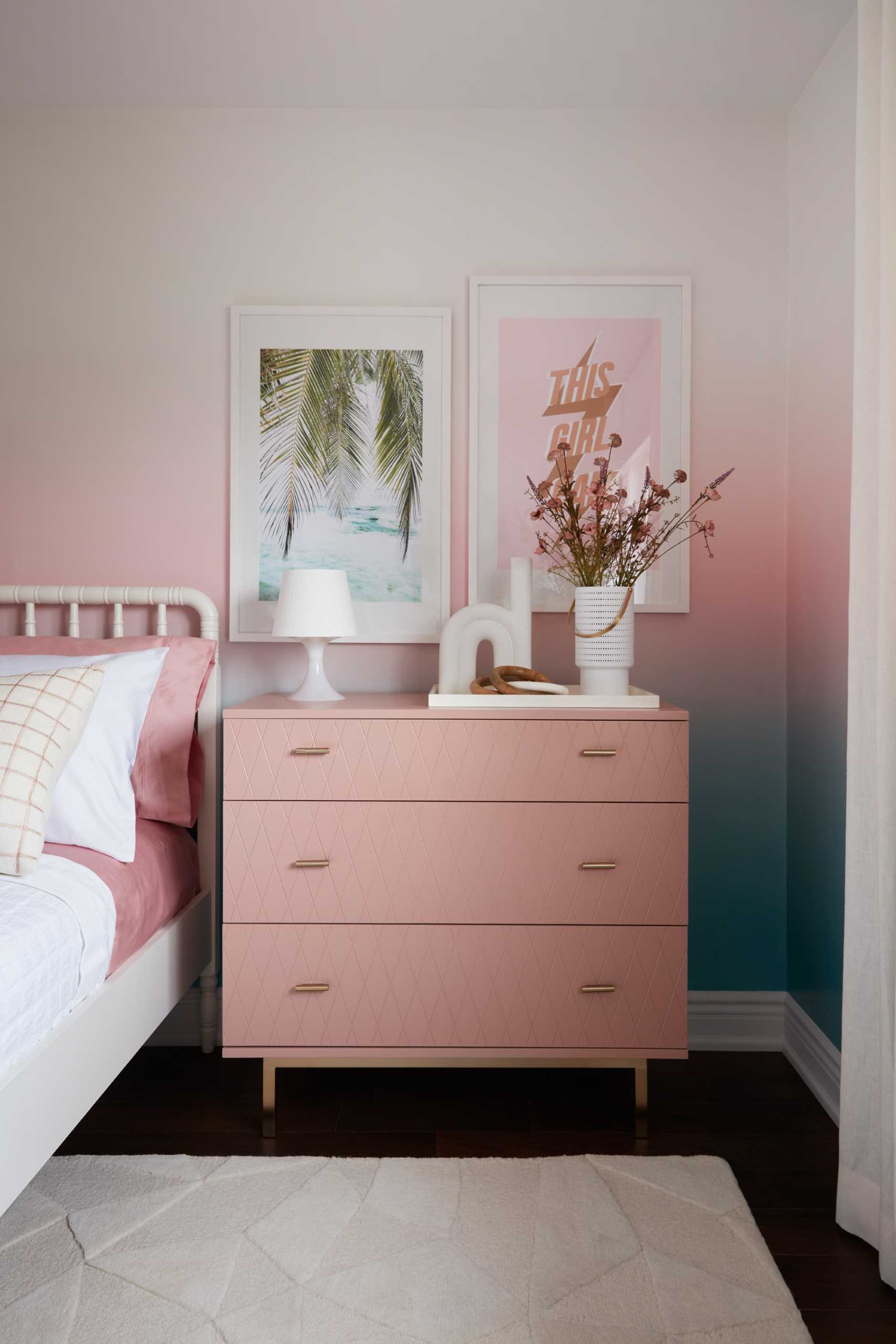 A colorful bedroom includes blue-to-pink ombre wallpaper with matching furniture and accessories.