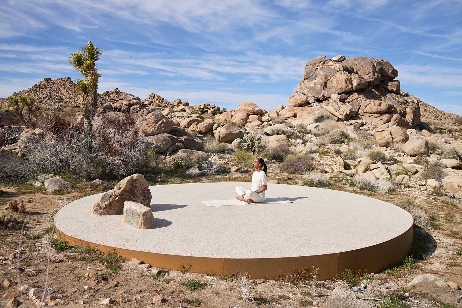 Concealed from the courtyard, but intimately tucked away just around the corner, there's a sculptural landing pad with yoga mats framed by oxidized solid steel. 