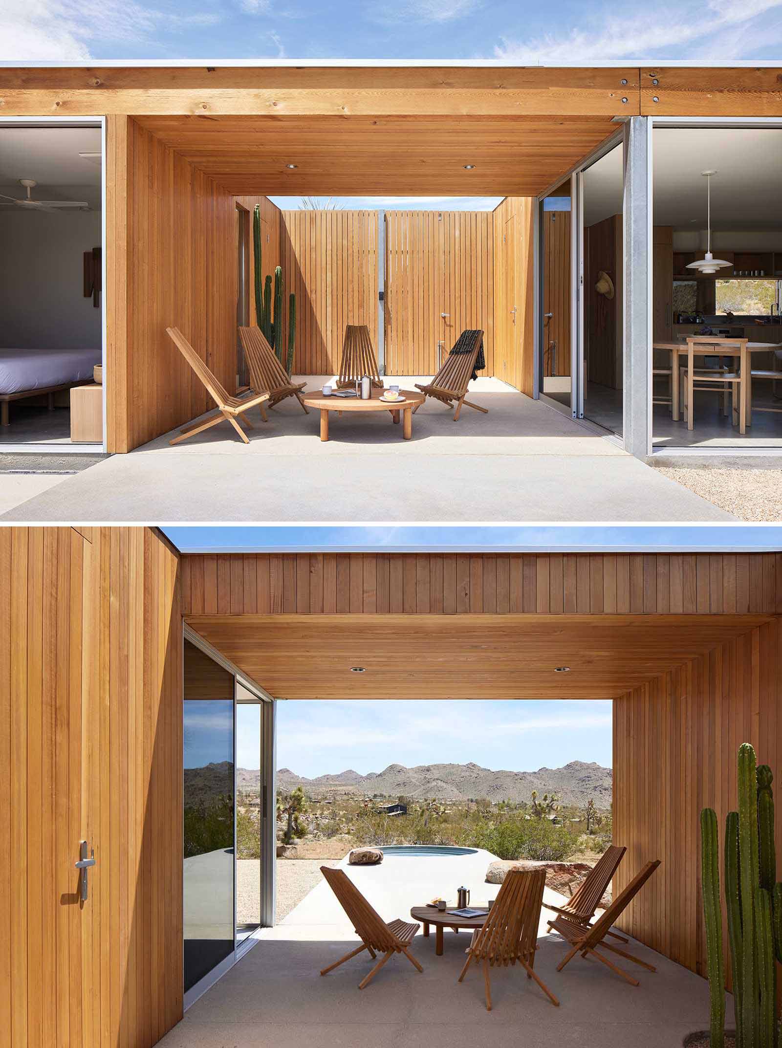 A desert home with wood siding that blends into its surrounding, includes a covered breezeway.