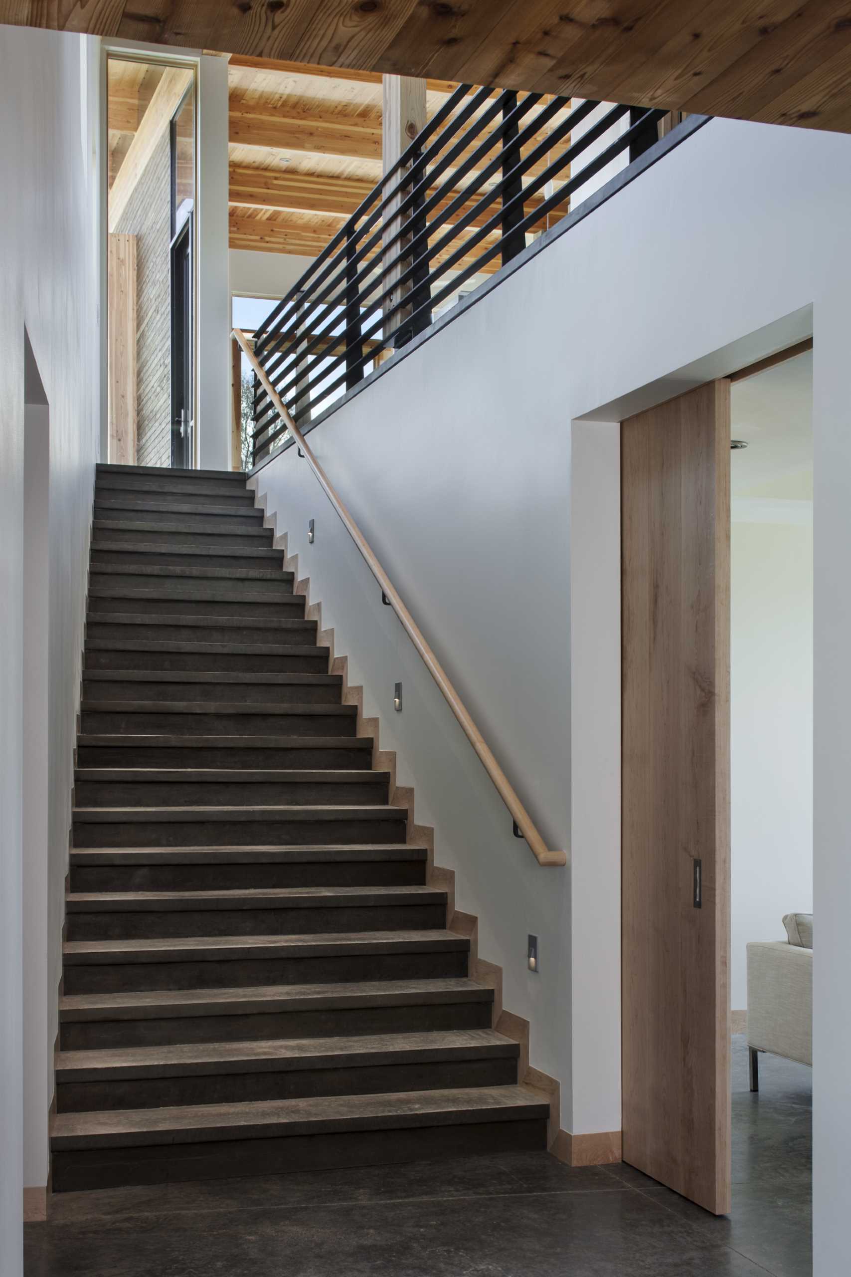 Contemporary stairs connect the levels of this home.