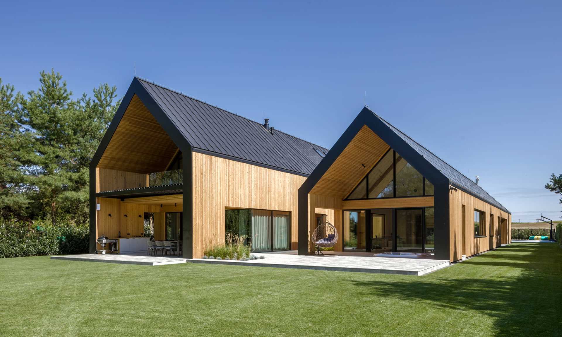 A modern house that has a layout similar to two barns positioned side-by-side.