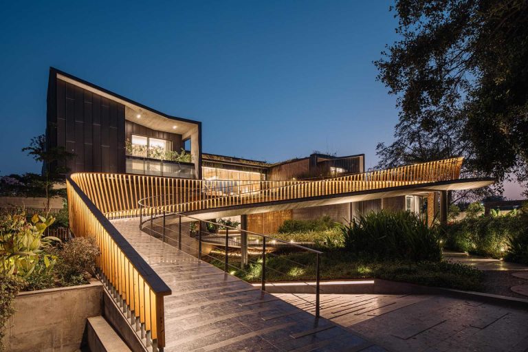 A Curving Bridge Leads To The Entertainment Areas Of This Modern Home