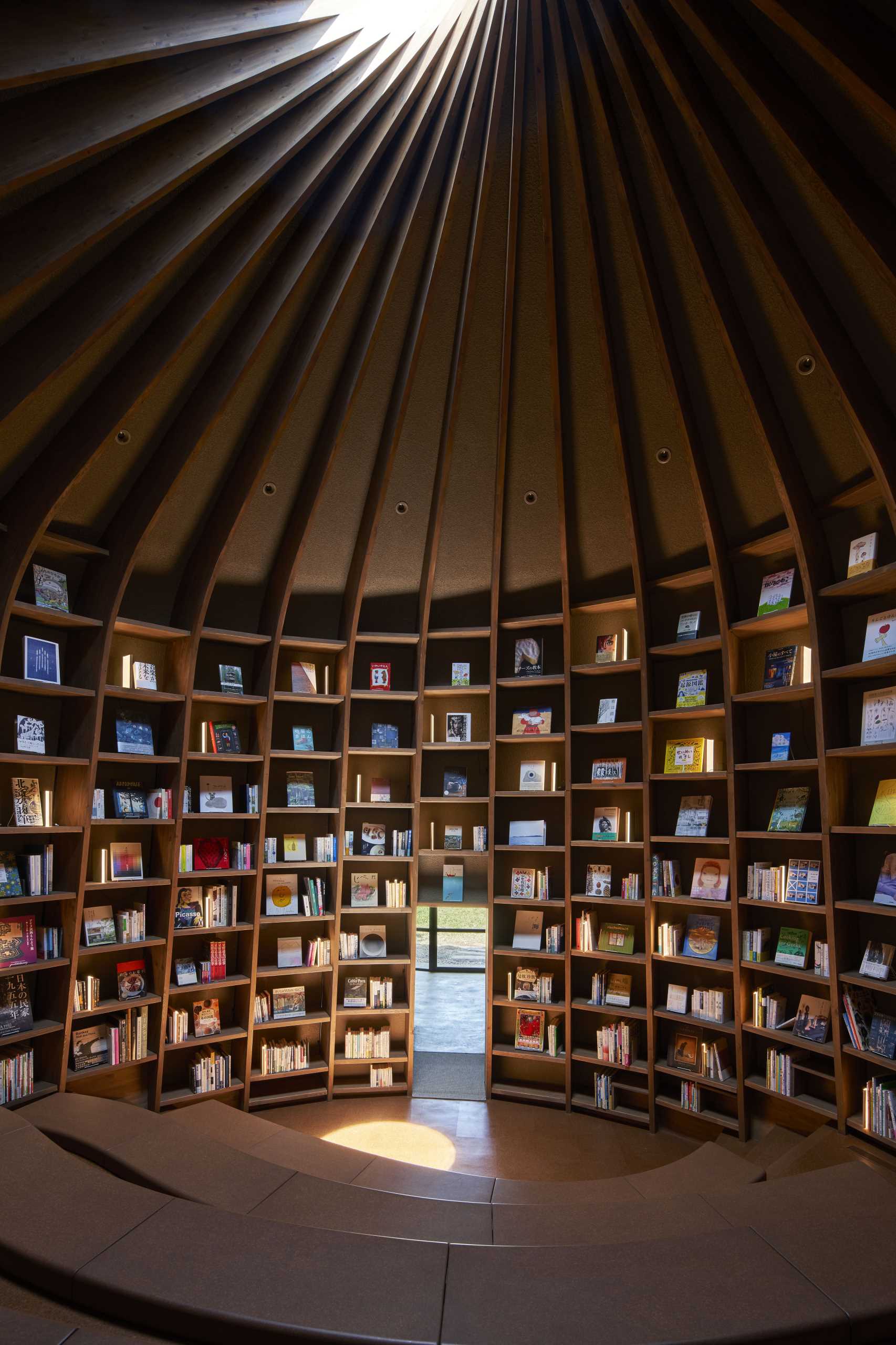 A modern library that's built into the earth includes a storytelling room with a skylight.