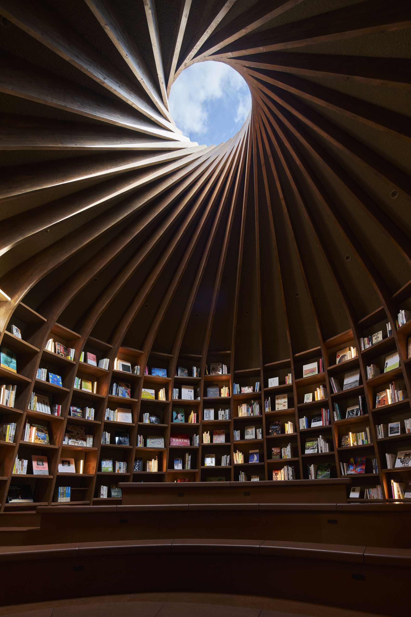 A modern library that's built into the earth includes a storytelling room with a skylight.