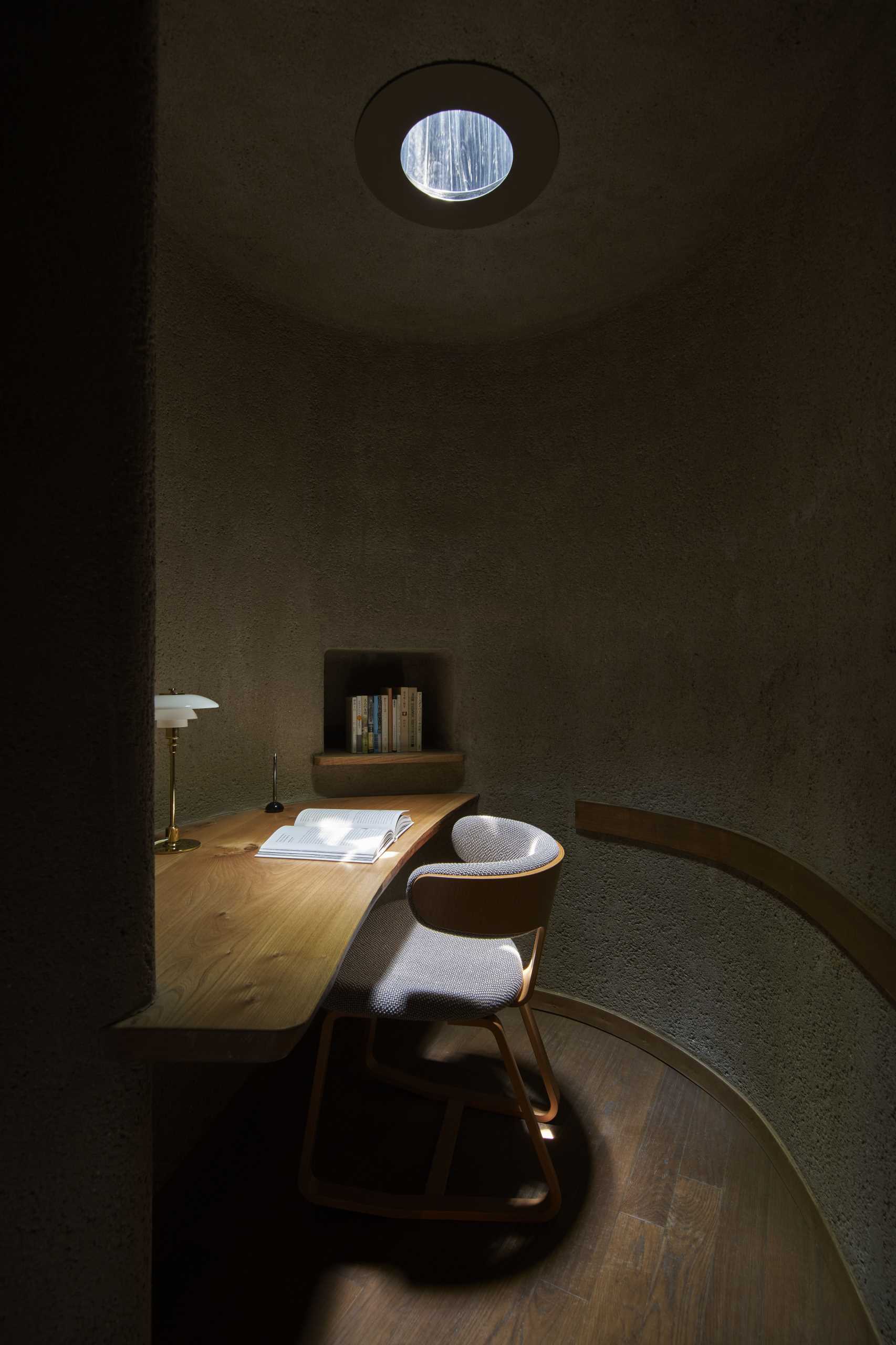 A small reading room in a library, that includes a skylight.