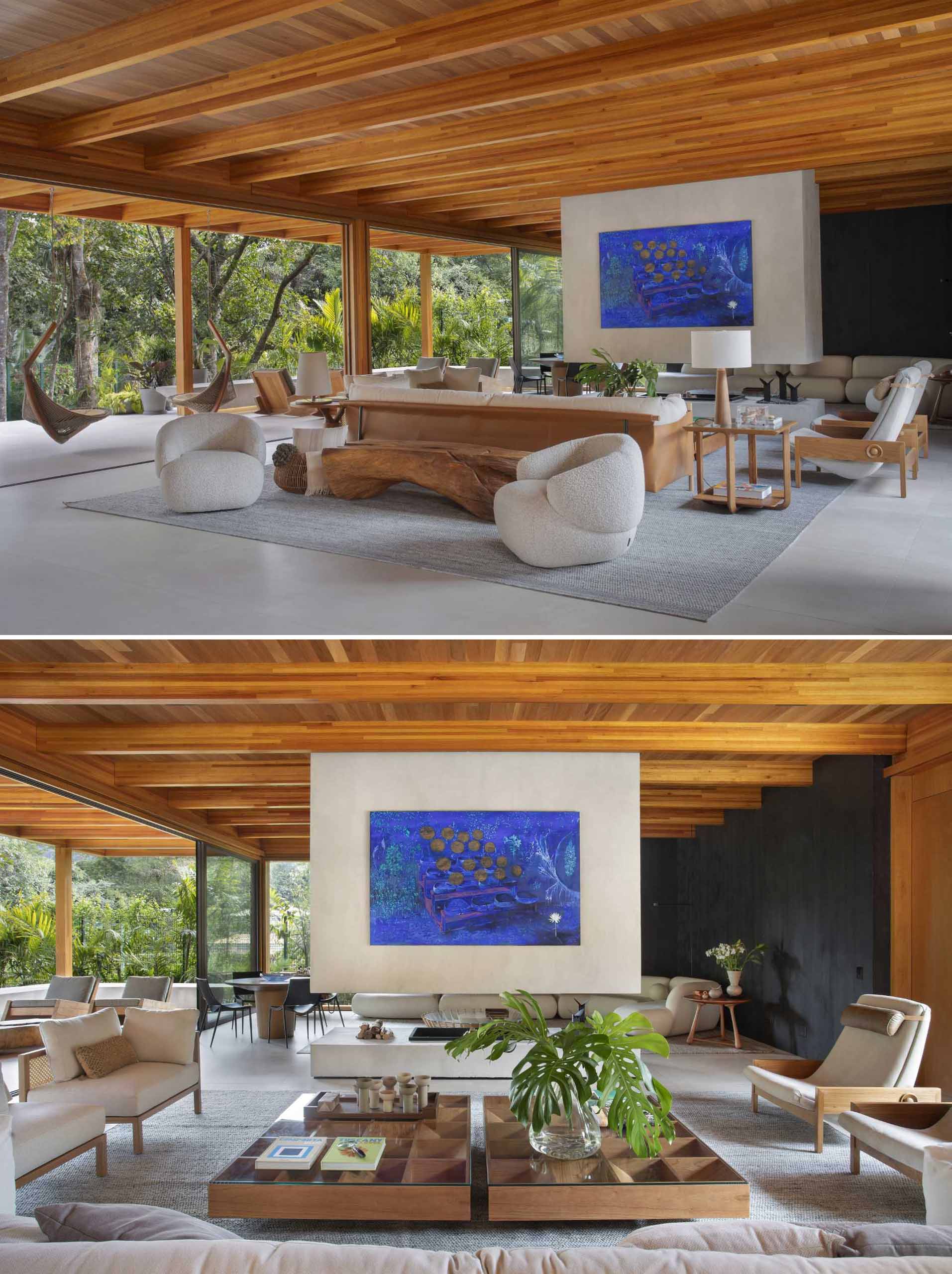 Stepping inside this modern home, there's a large living room with the post and beam structure on display. A double-sided, suspended fireplace can be enjoyed from the sitting area. 