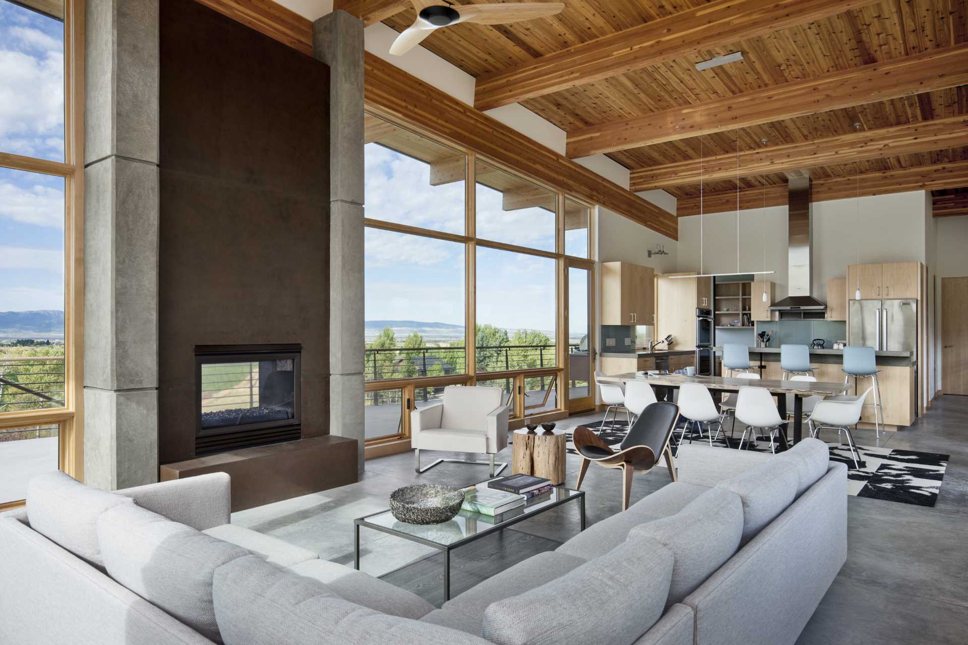 A contemporary open plan interior with the living room, dining area, and kitchen sharing the same place.