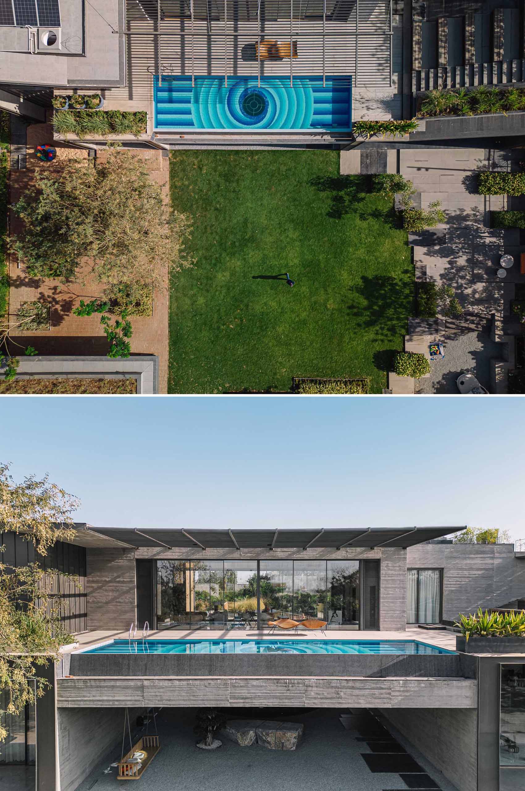 A decorative pattern of various blue shades lines the bottom of the pool, while the center of the pool has a window that shows the covered outdoor space below. 