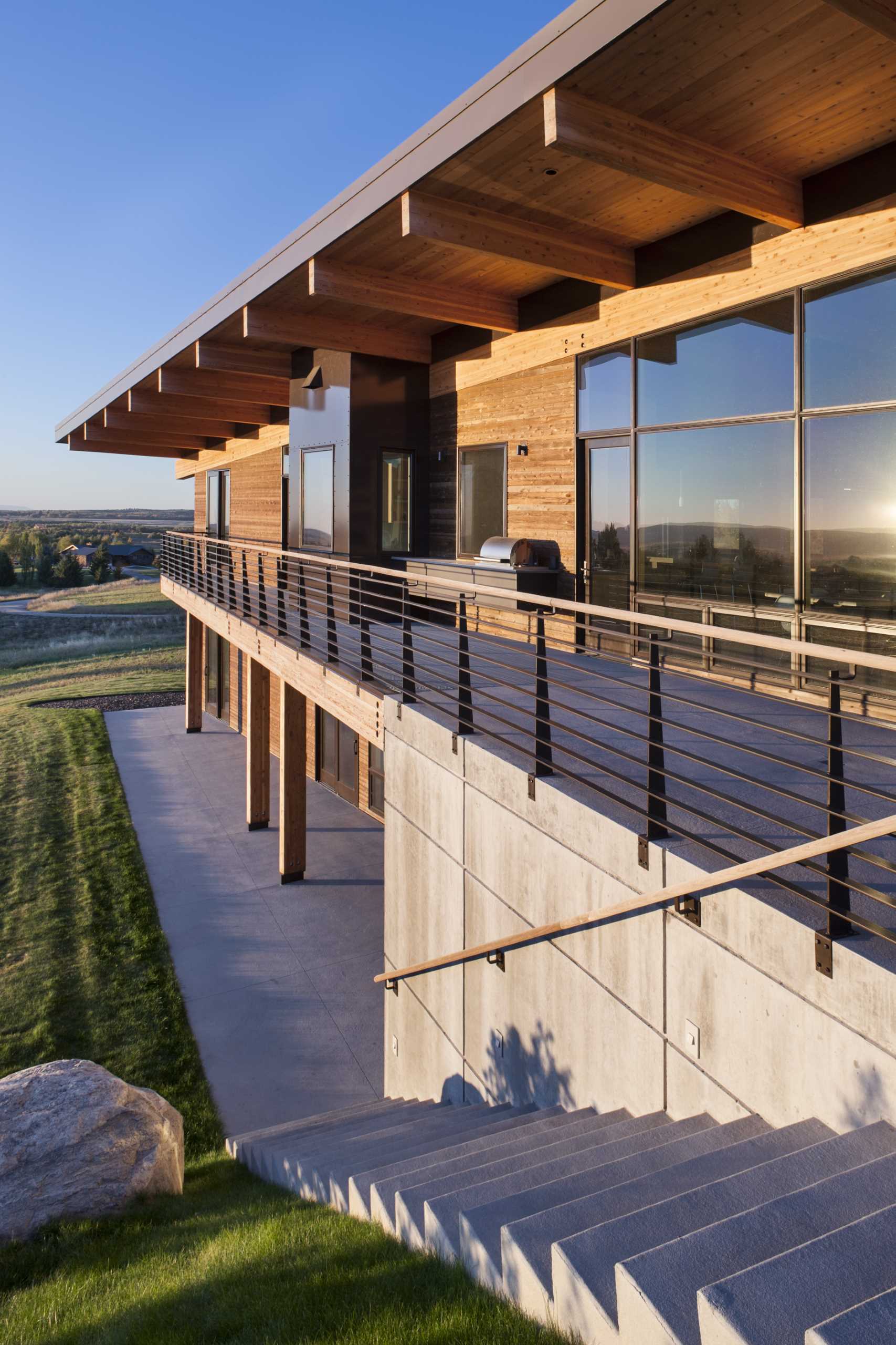 A modern post and beam house with wood siding.