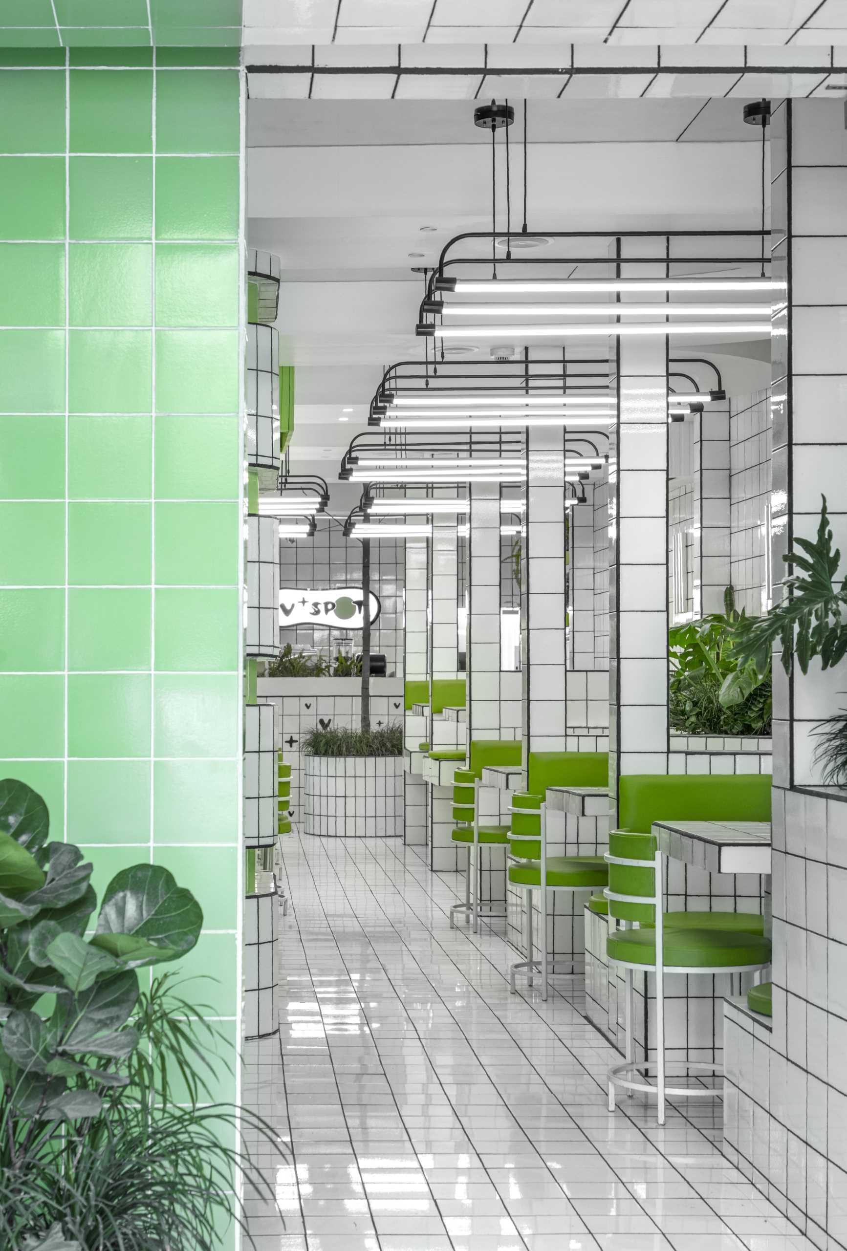 A modern green and white tiled cafe.