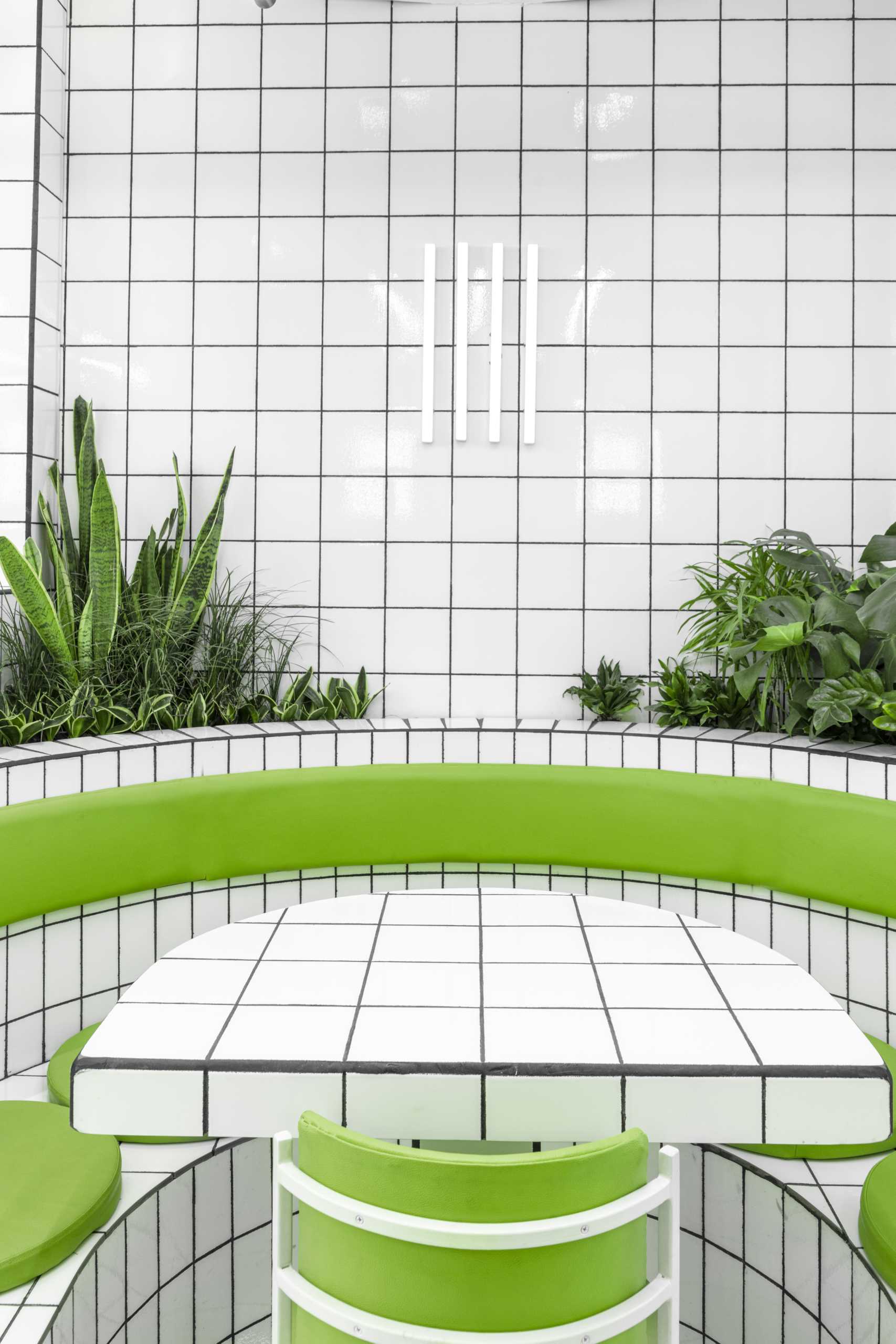 A modern green and white tiled cafe.