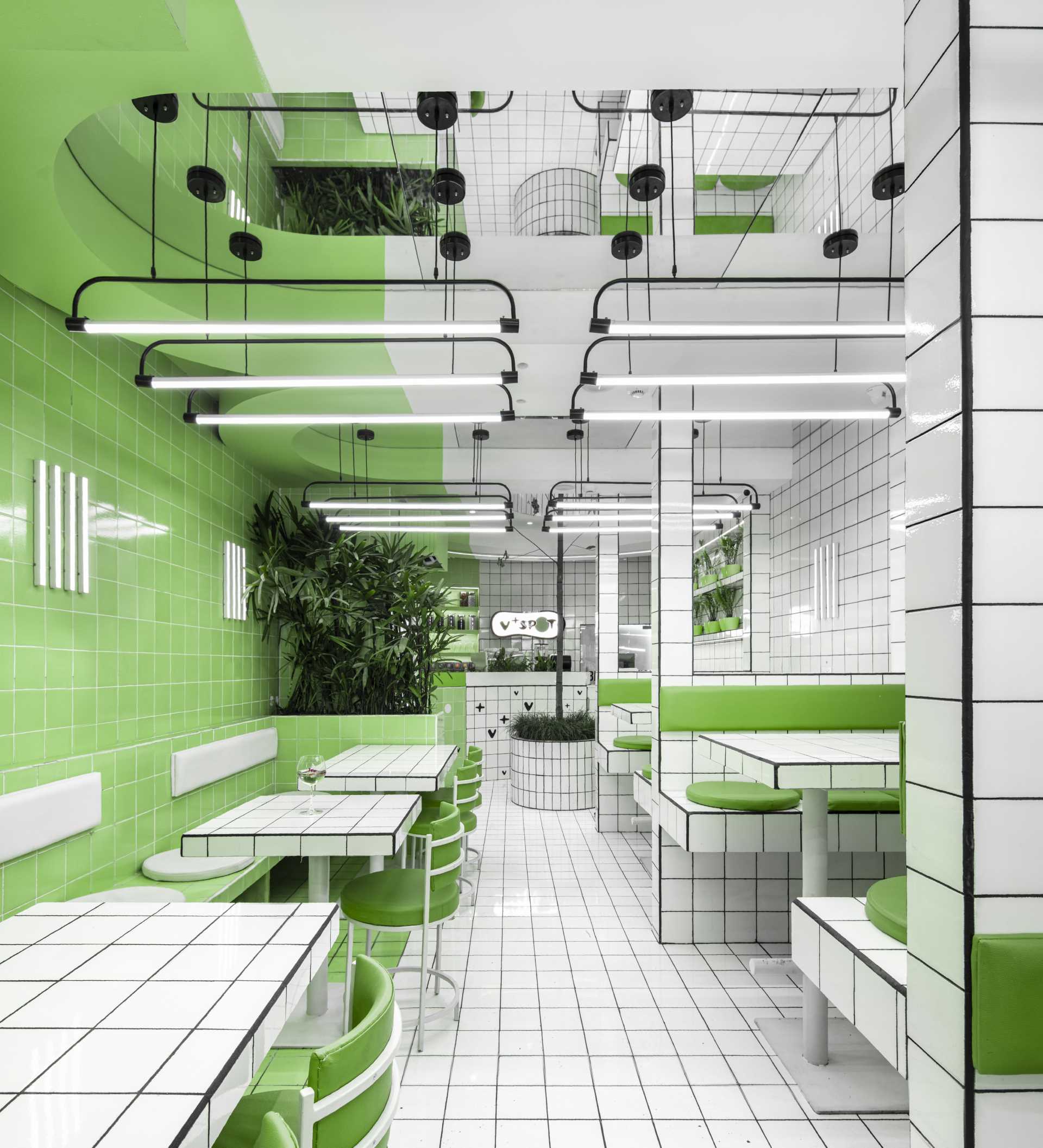 A modern green and white tiled cafe.