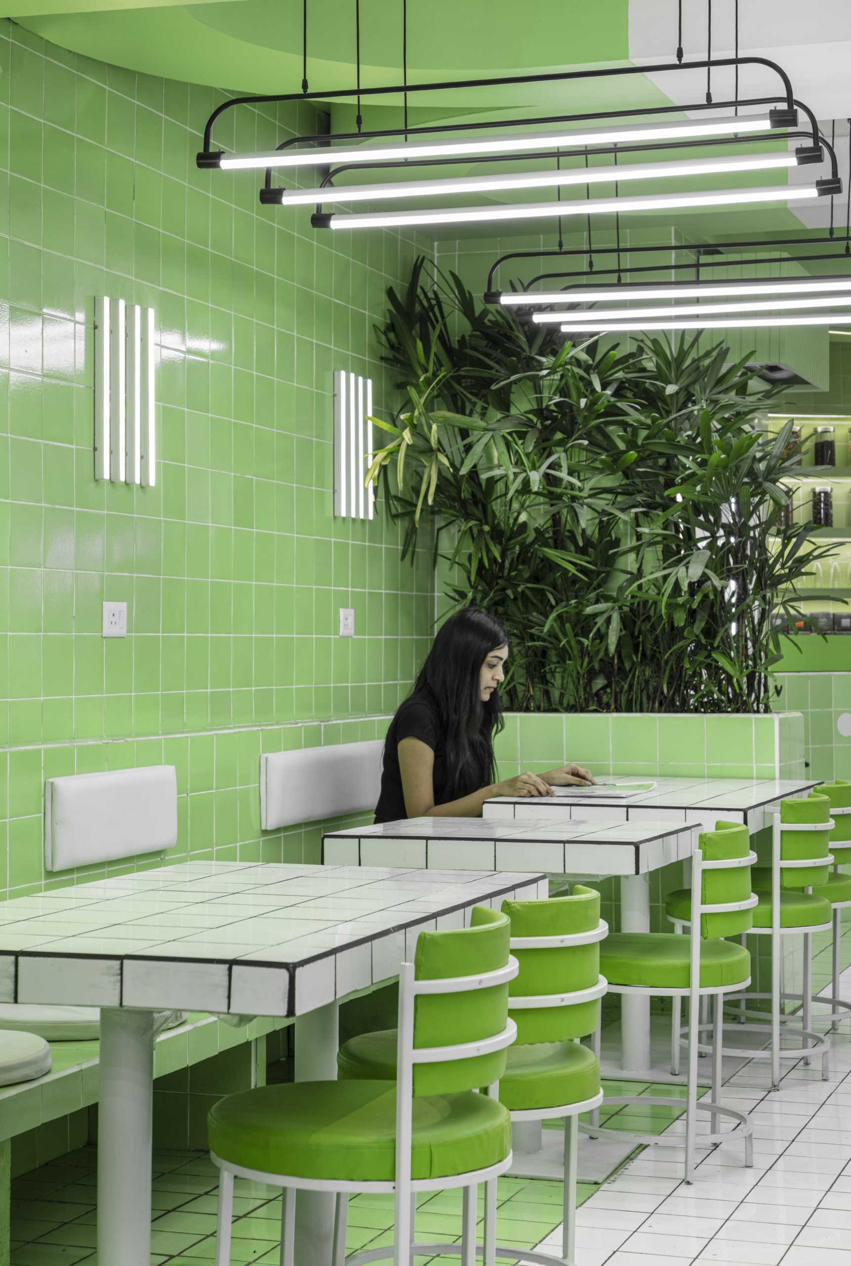 A modern green and white tiled cafe.