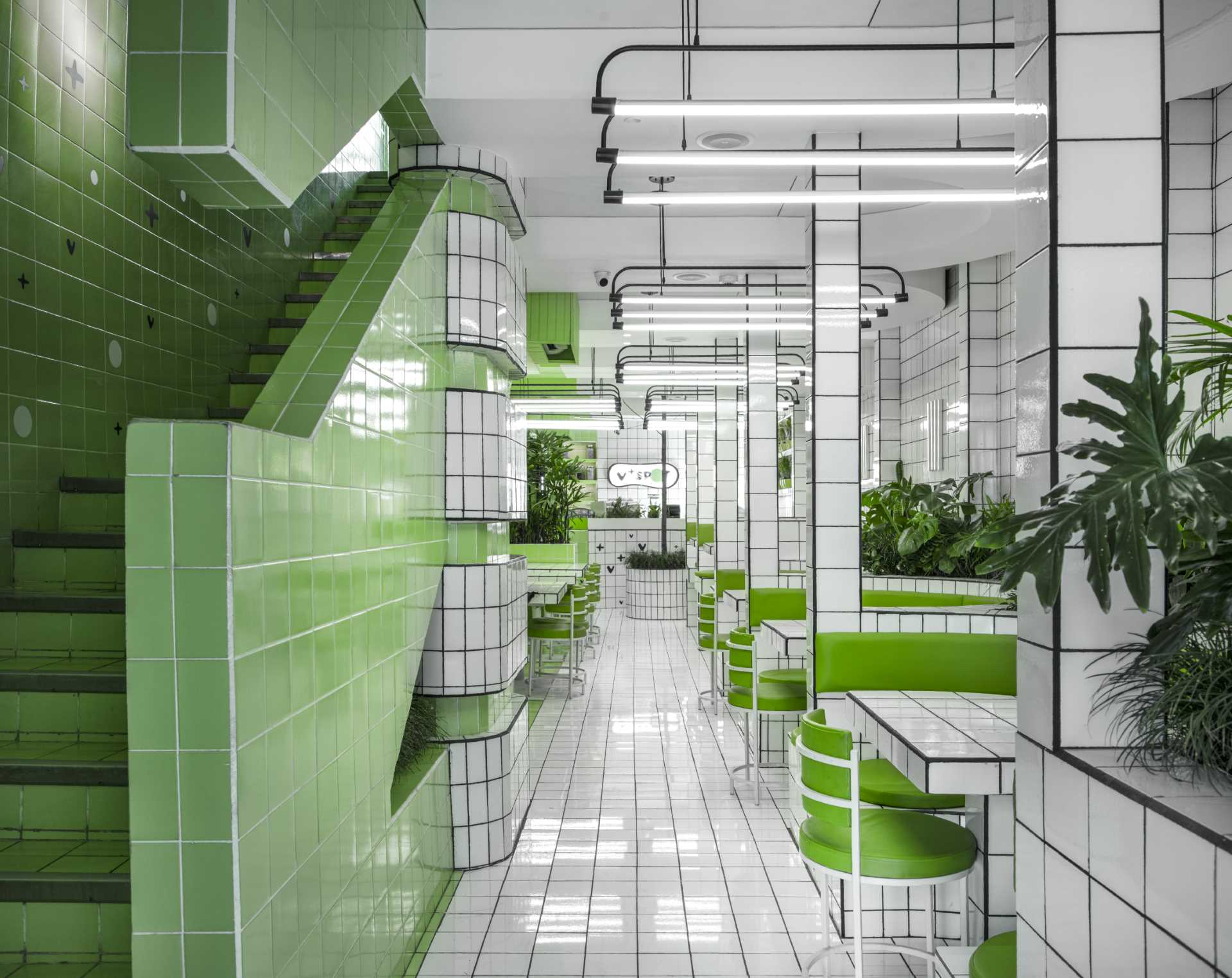 A modern green and white tiled cafe.