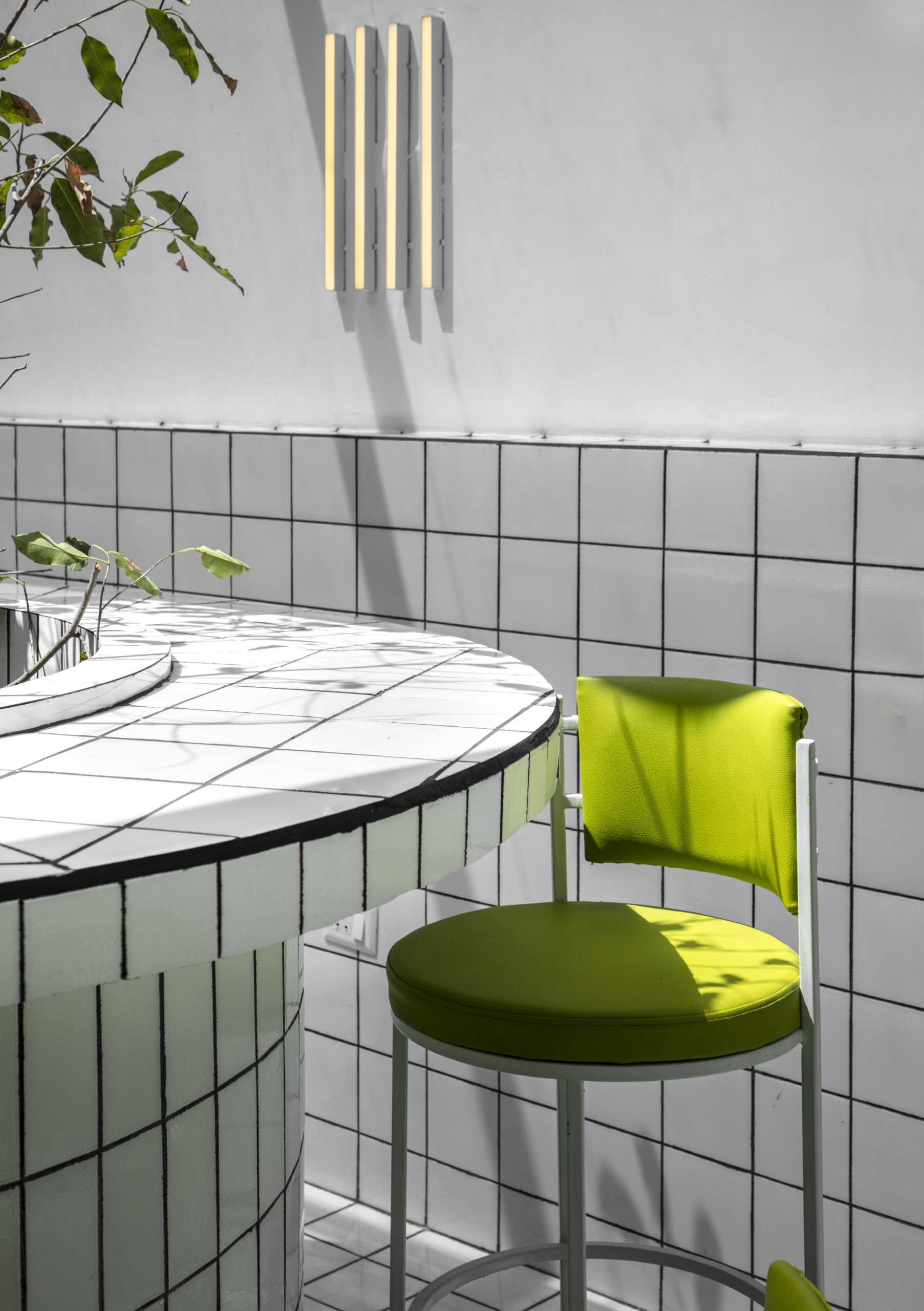 A modern green and white tiled cafe.