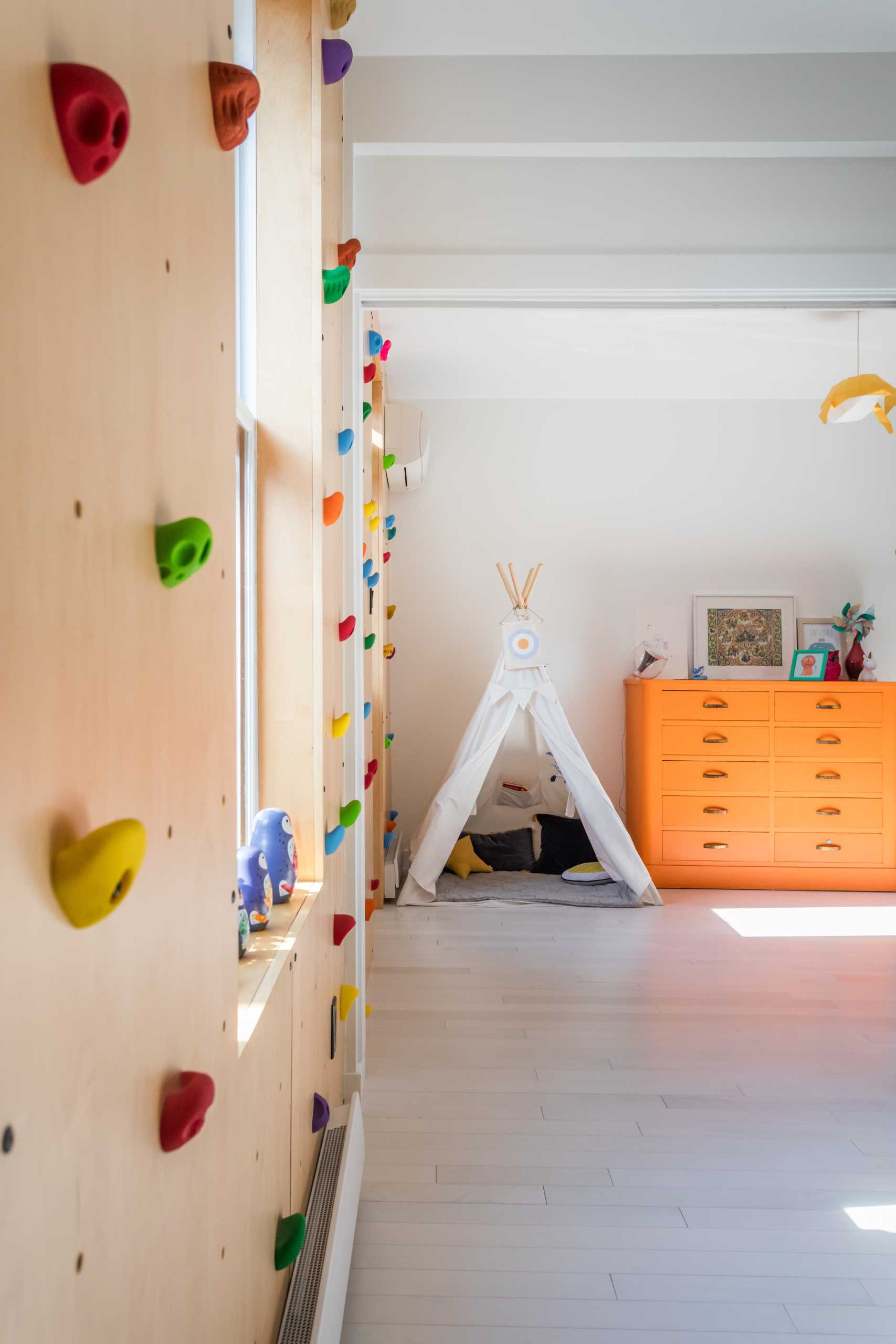 A rock-climbing wall decorates the children’s bedroom and adds a colorful accent.