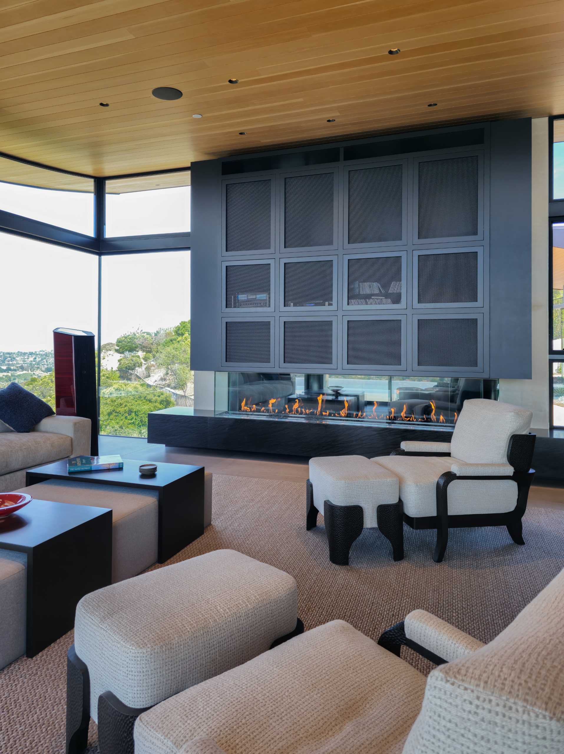 A modern living room with a fireplace and bar.