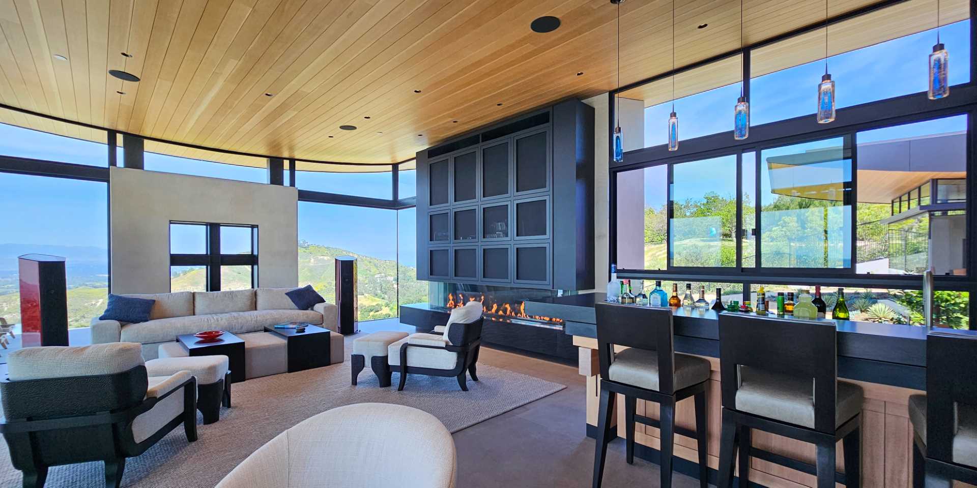 A modern living room with a fireplace and bar.