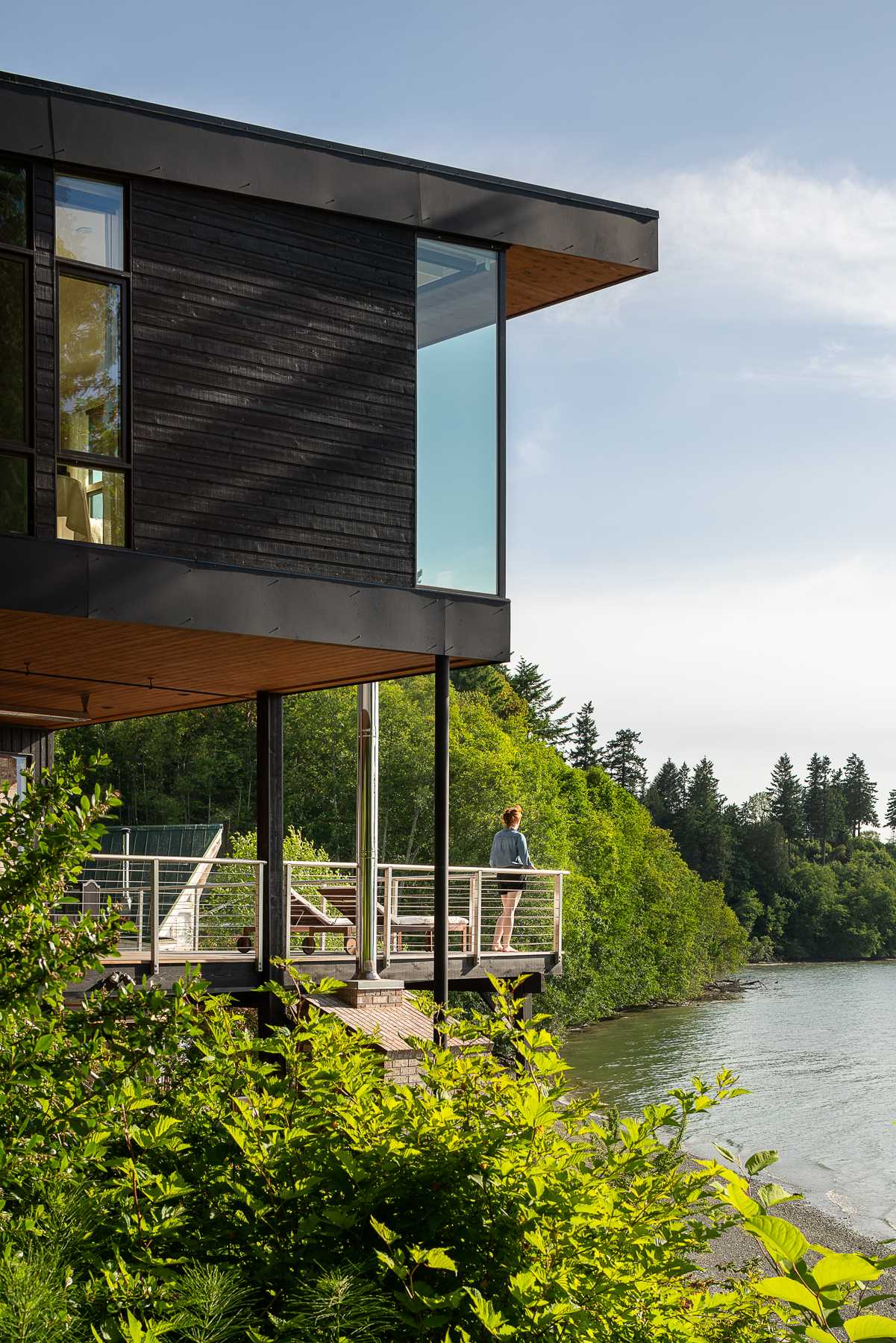 A modern beach house with black-stained and natural cedar siding.