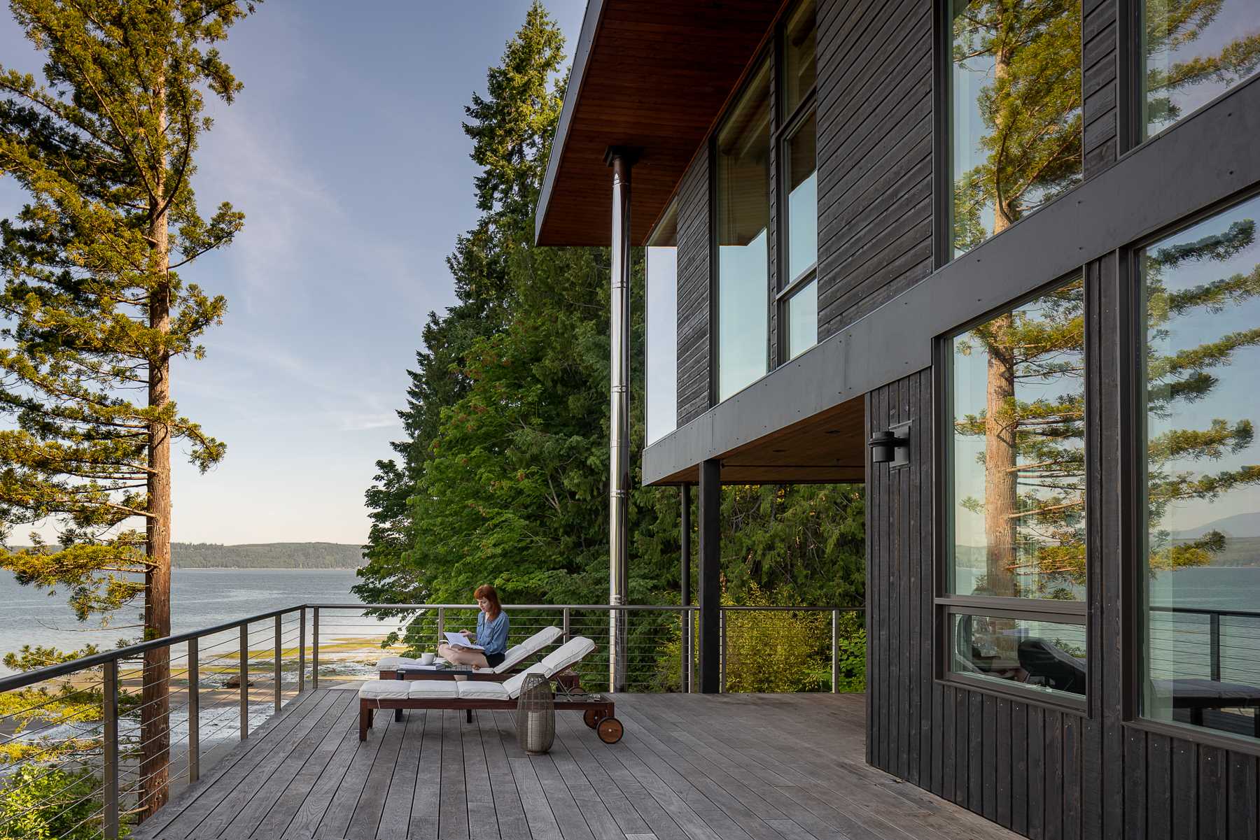 A modern beach house with black-stained and natural cedar siding.