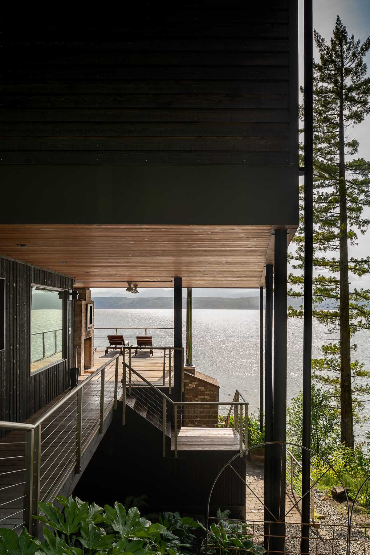 A modern beach house with black-stained and natural cedar siding.