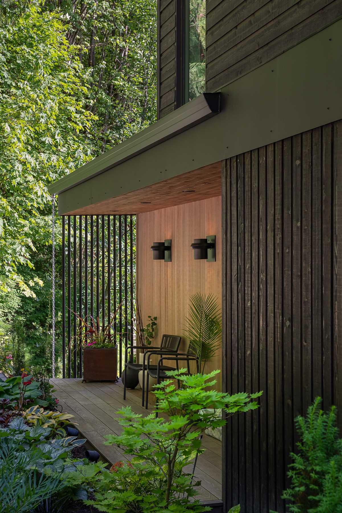 A modern beach house with black-stained and natural cedar siding.