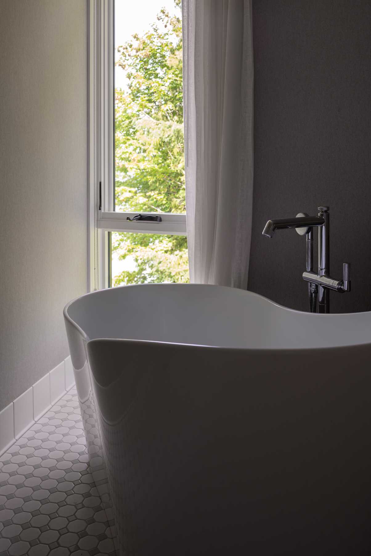 A contemporary bathroom with a freestanding bathtub.