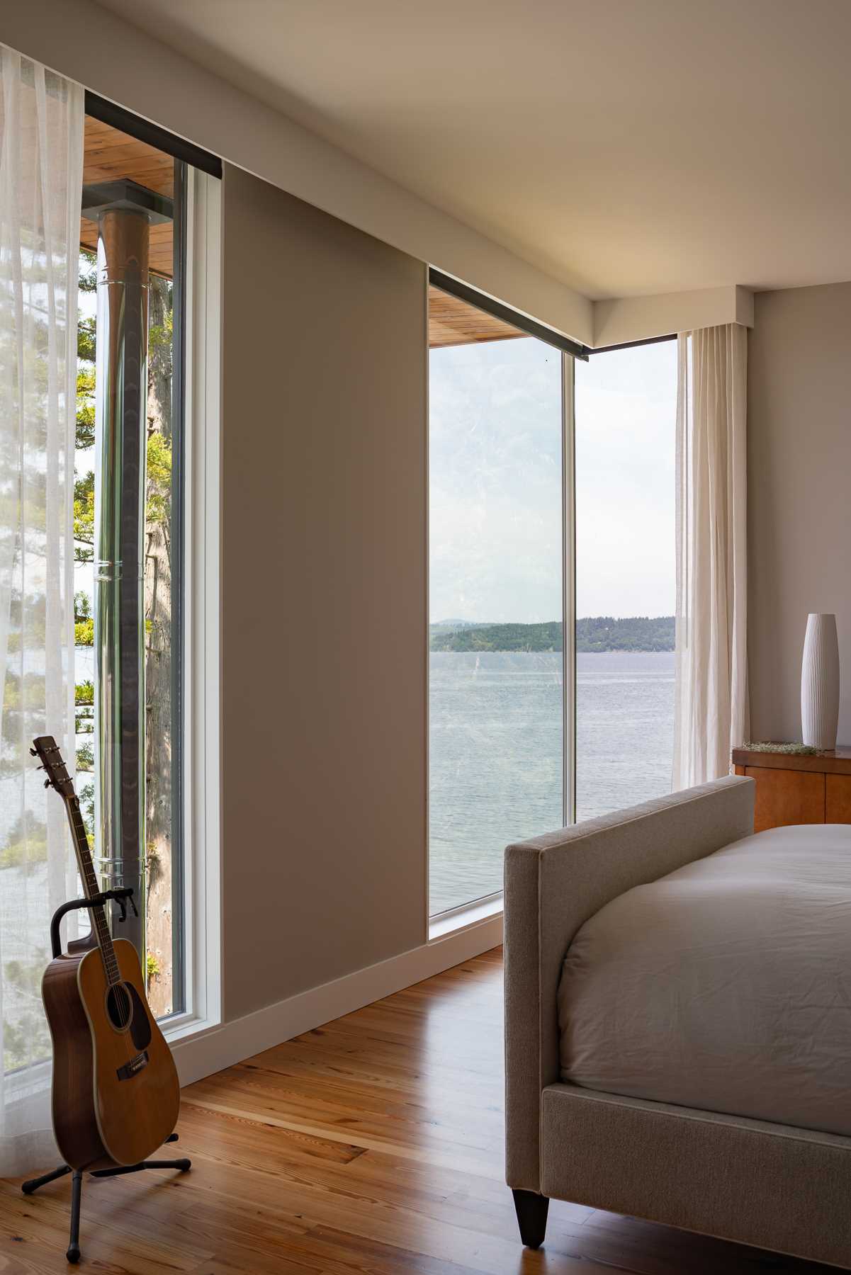 A contemporary bedroom with reclaimed wood flooring.