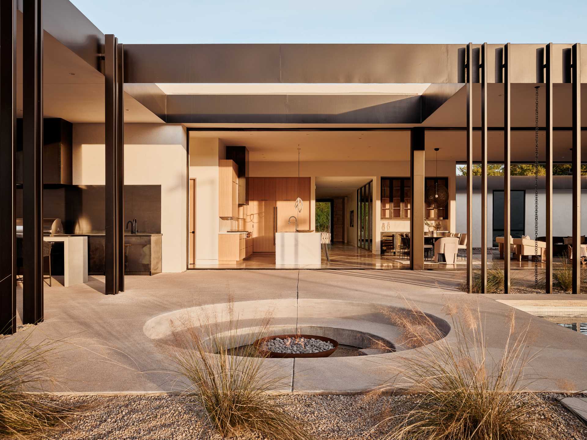 Between the pool and covered patio is a circular sunken fire pit that provides an intimate gathering space.