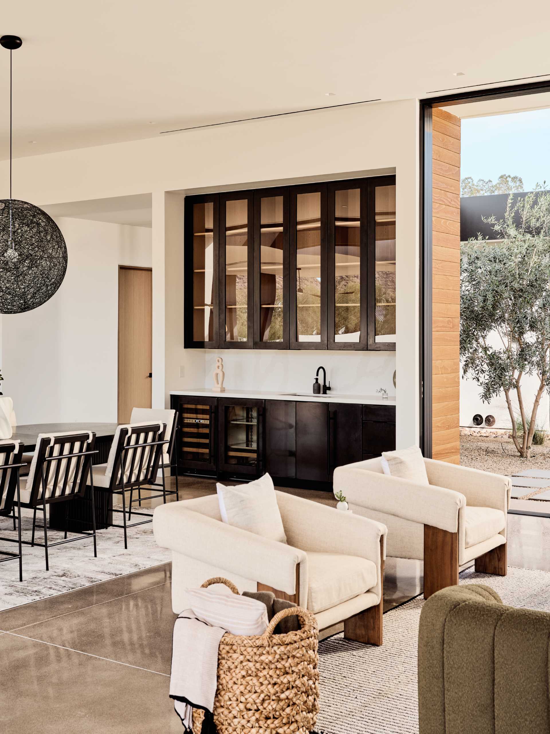 A modern open plan dining area separates the living room and the kitchen.