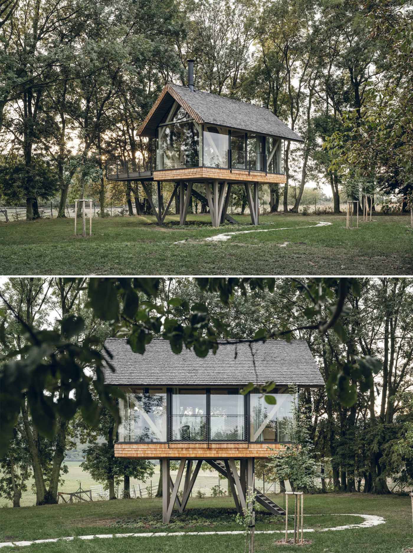 A modern elevated cabin with glass walls, a bed, a bar, and a fireplace.