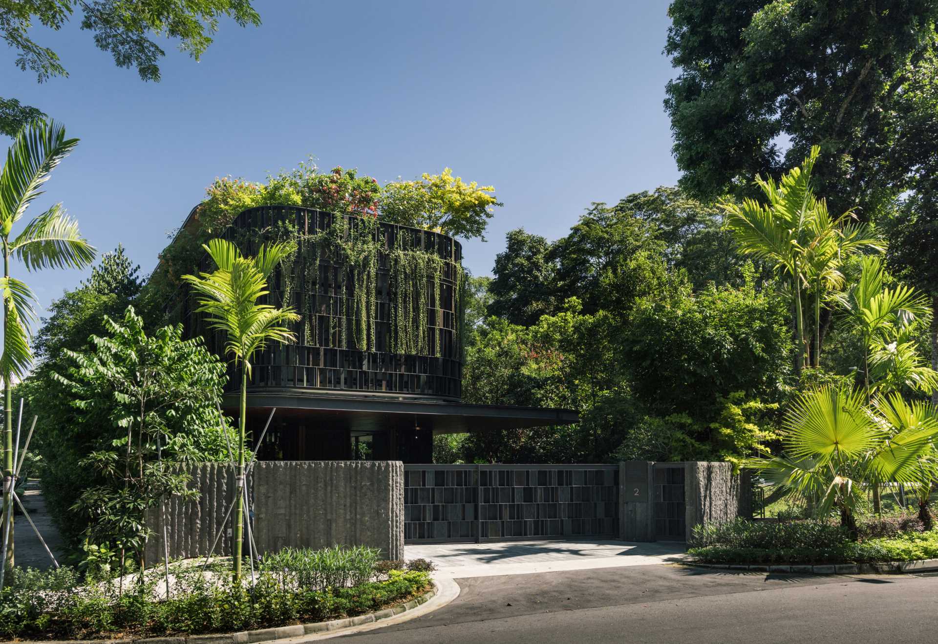 A modern house in Singapore that has plants and shade screens integrated into its design.