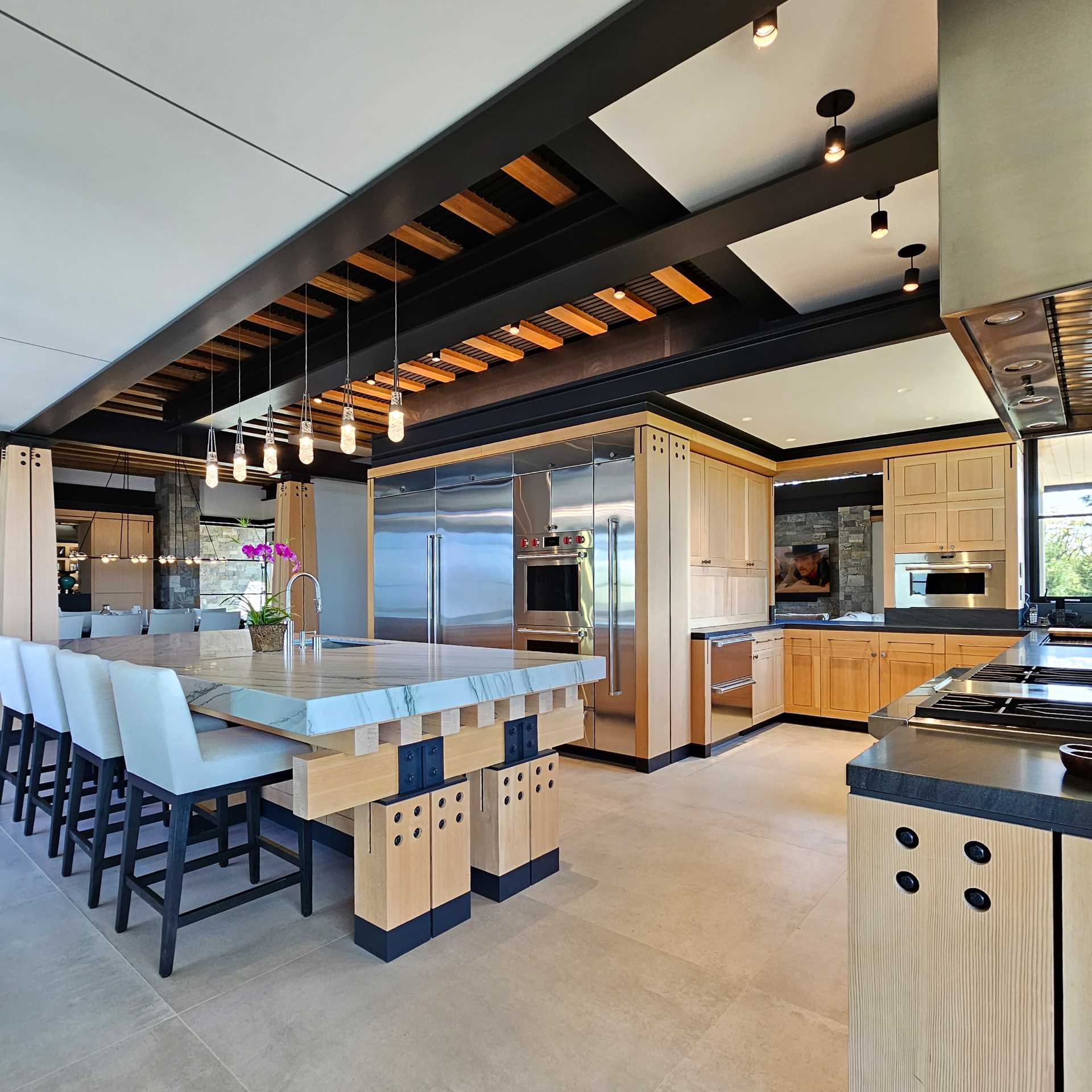 The focal point of this kitchen is the wood trestle center island that combines functionality with neo-rustic charm. Its robust presence serves as both a culinary workspace and a social hub. 