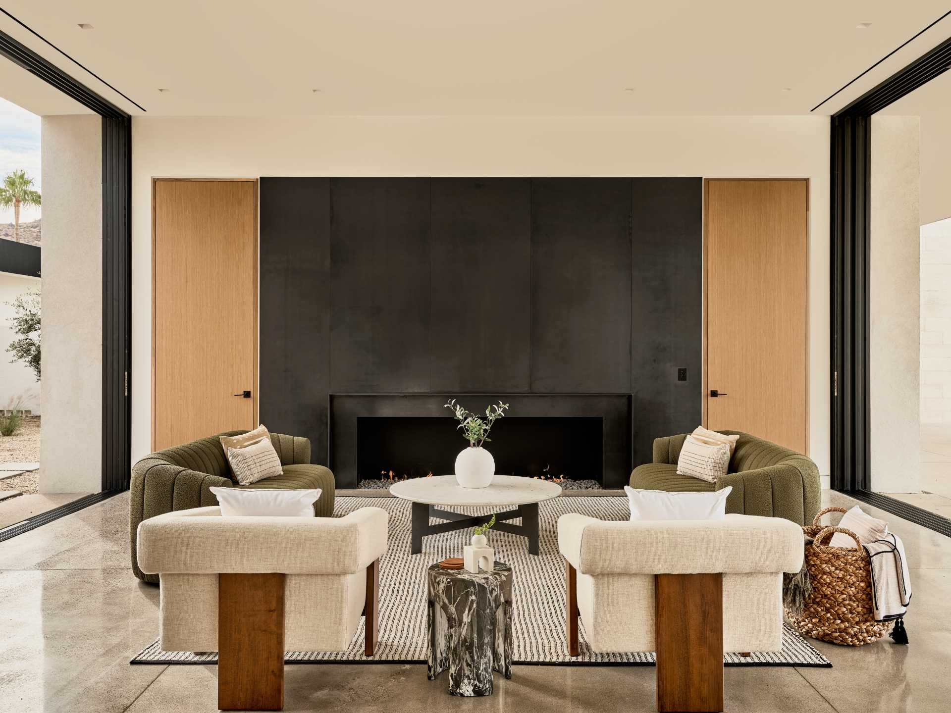 A large, steel-clad fireplace anc،rs the living room in this great room.