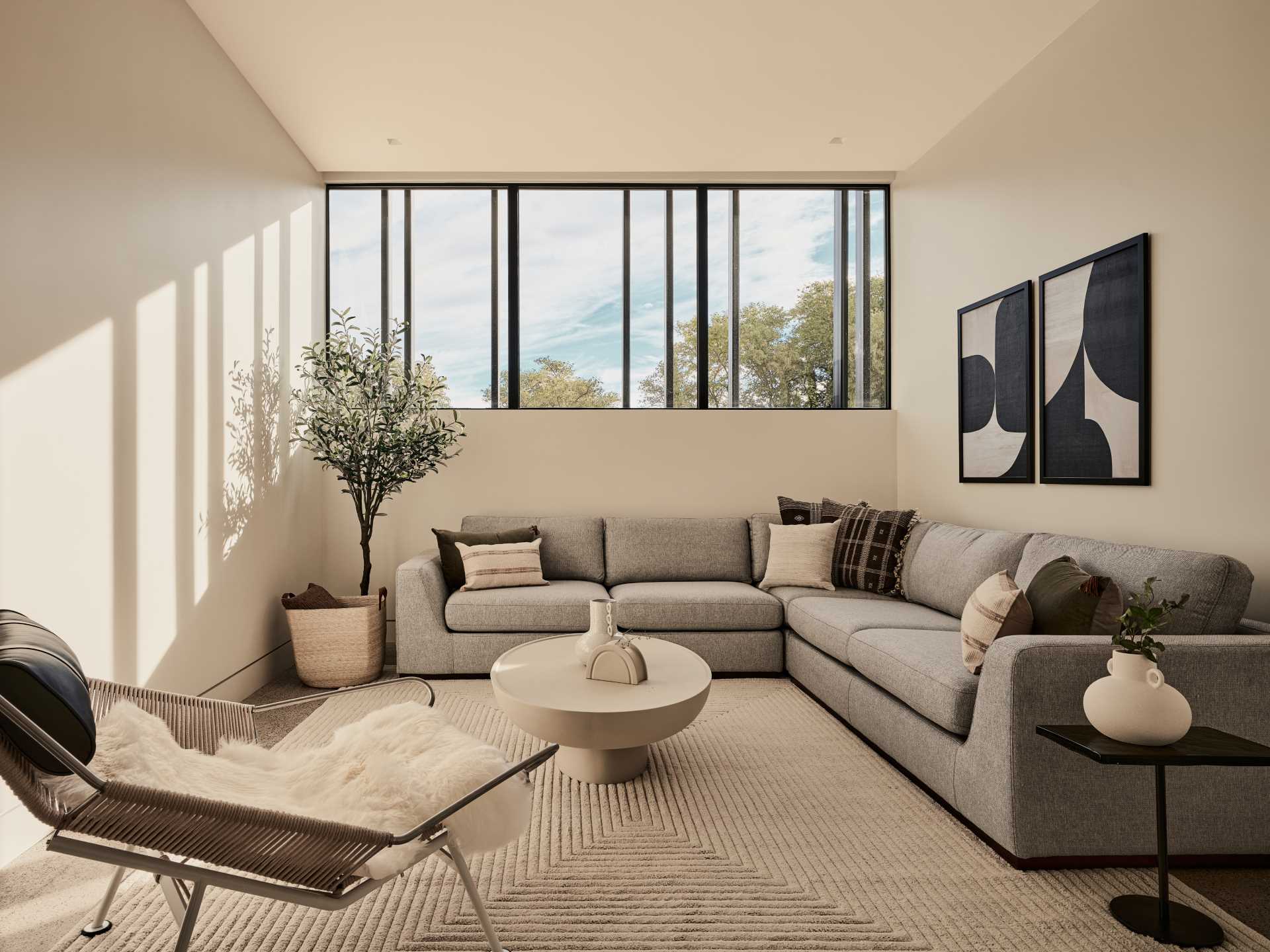 A contemporary living room filled with neutral colors.