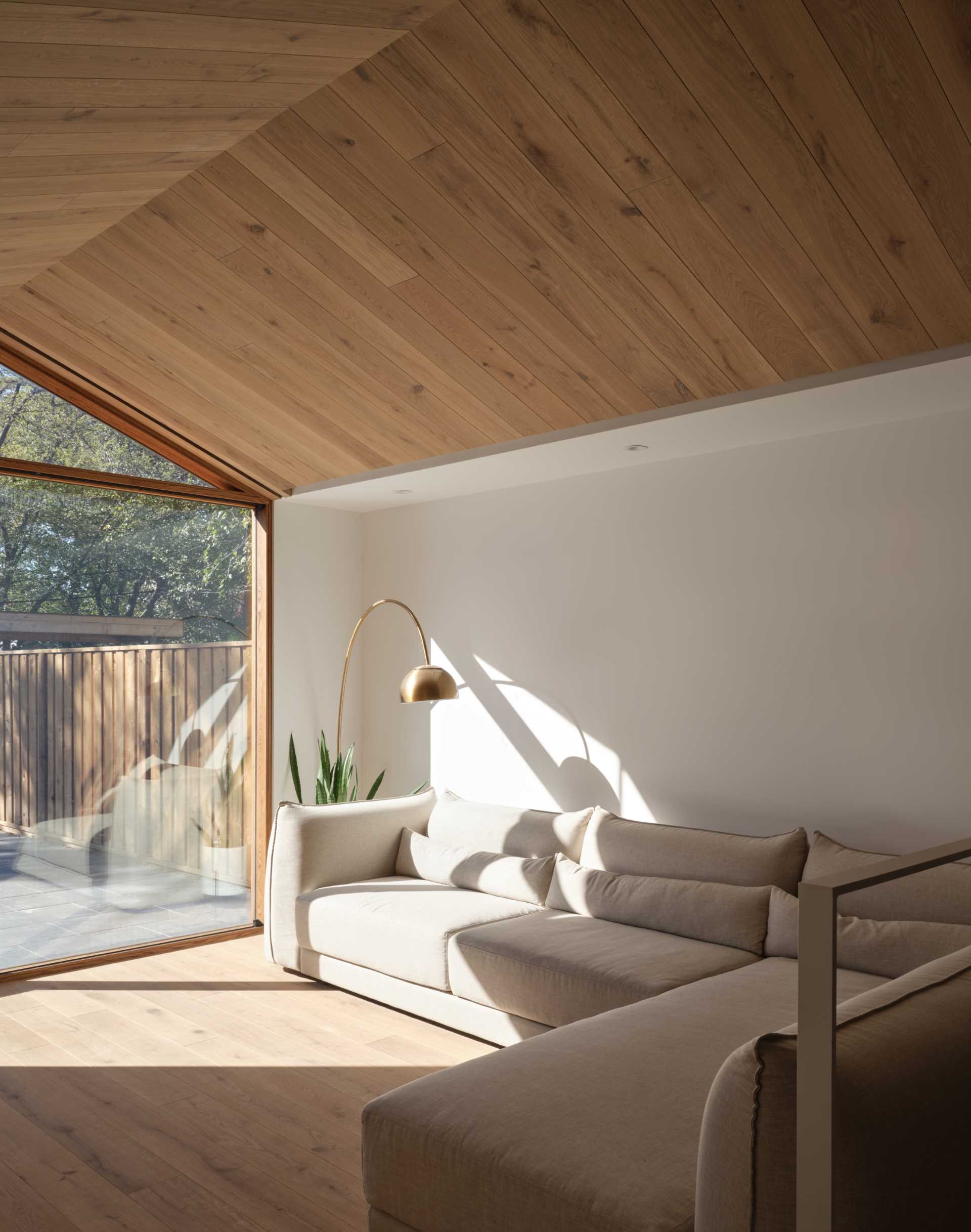 This modern living room looks out to the rear patio.