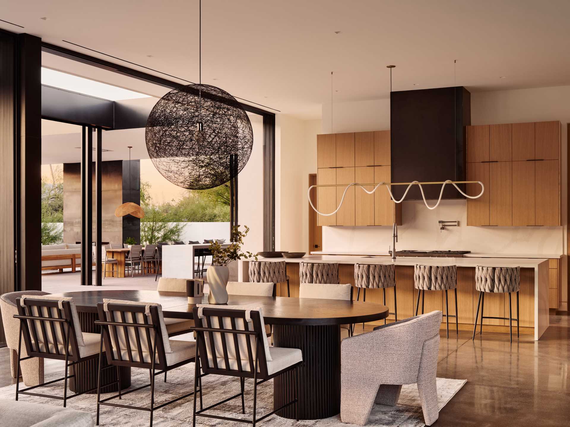 A modern open plan dining area separates the living room and the kitchen.