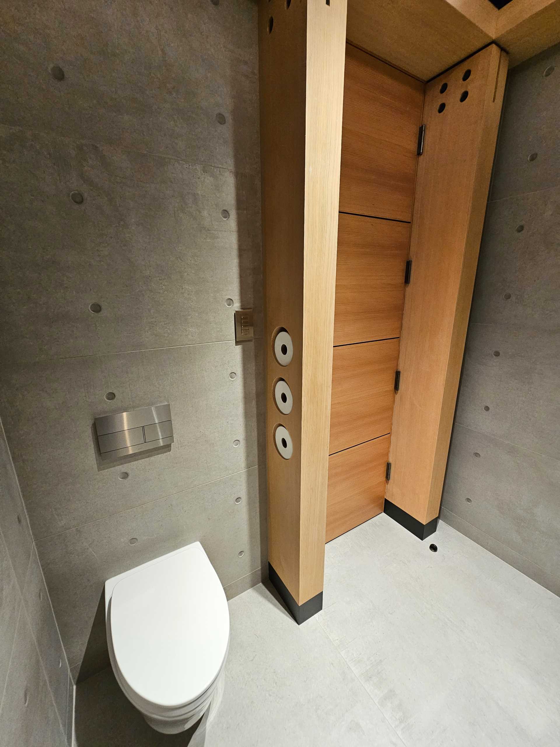 A modern powder room with the wood and steel structure on display.