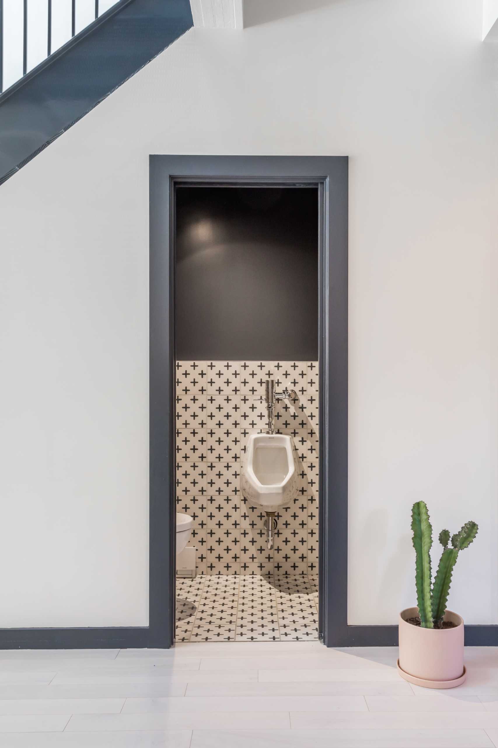 A modern home with a powder room under the stairs.