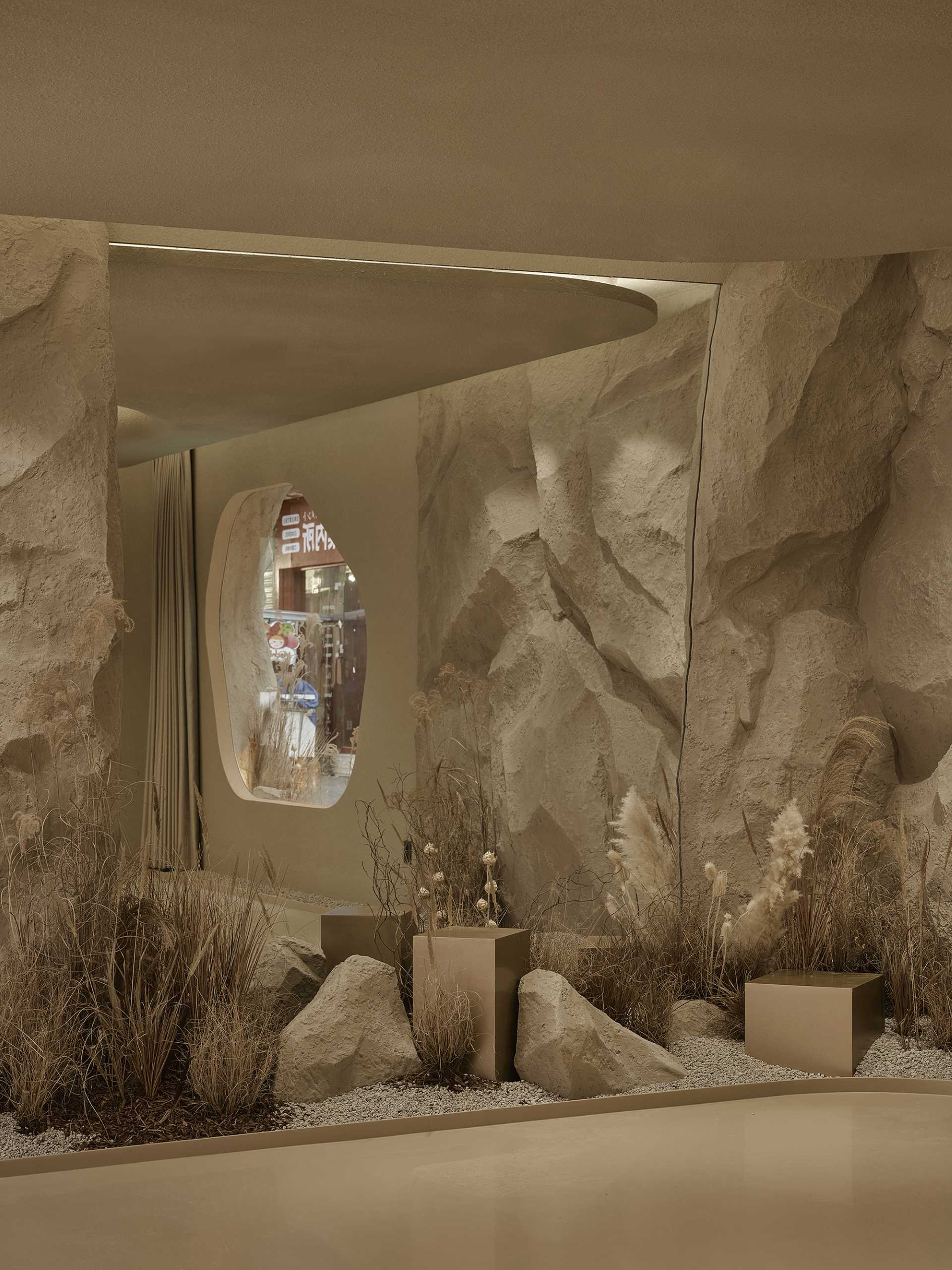 A modern skincare boutique inspired by "untouched nature" includes rock formations, warm brown tones, and a reed forest.