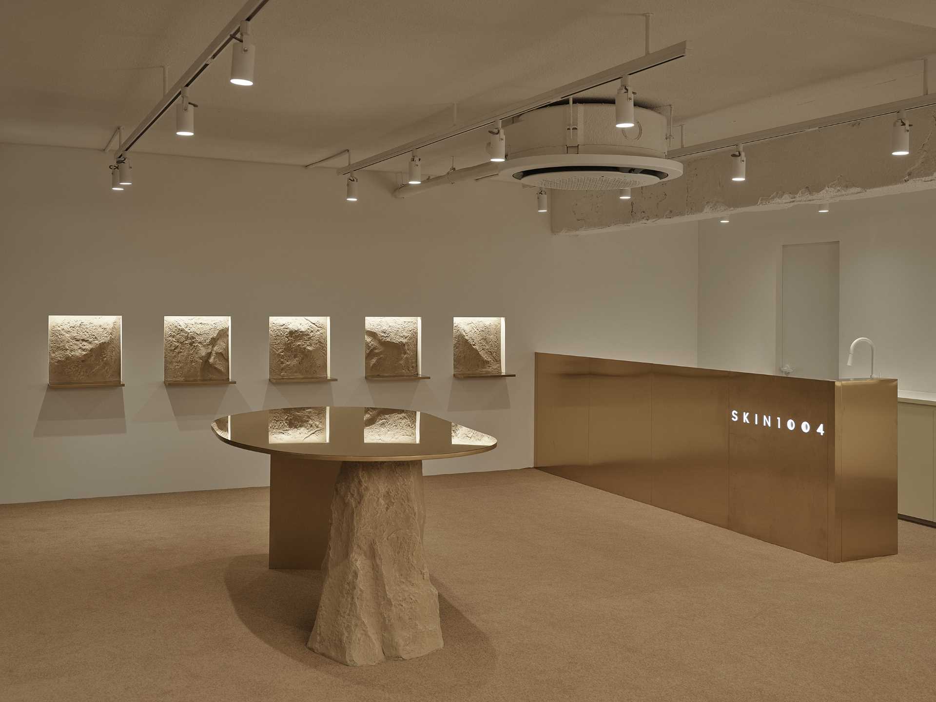 A modern skincare boutique inspired by "untouched nature" includes rock formations, warm brown tones, and a reed forest.