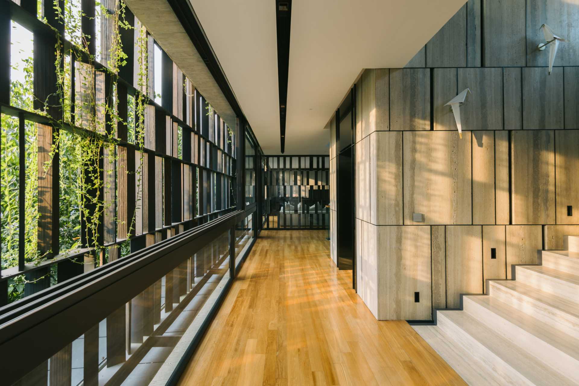 A modern house in Singapore that has plants and shade screens integrated into its design.